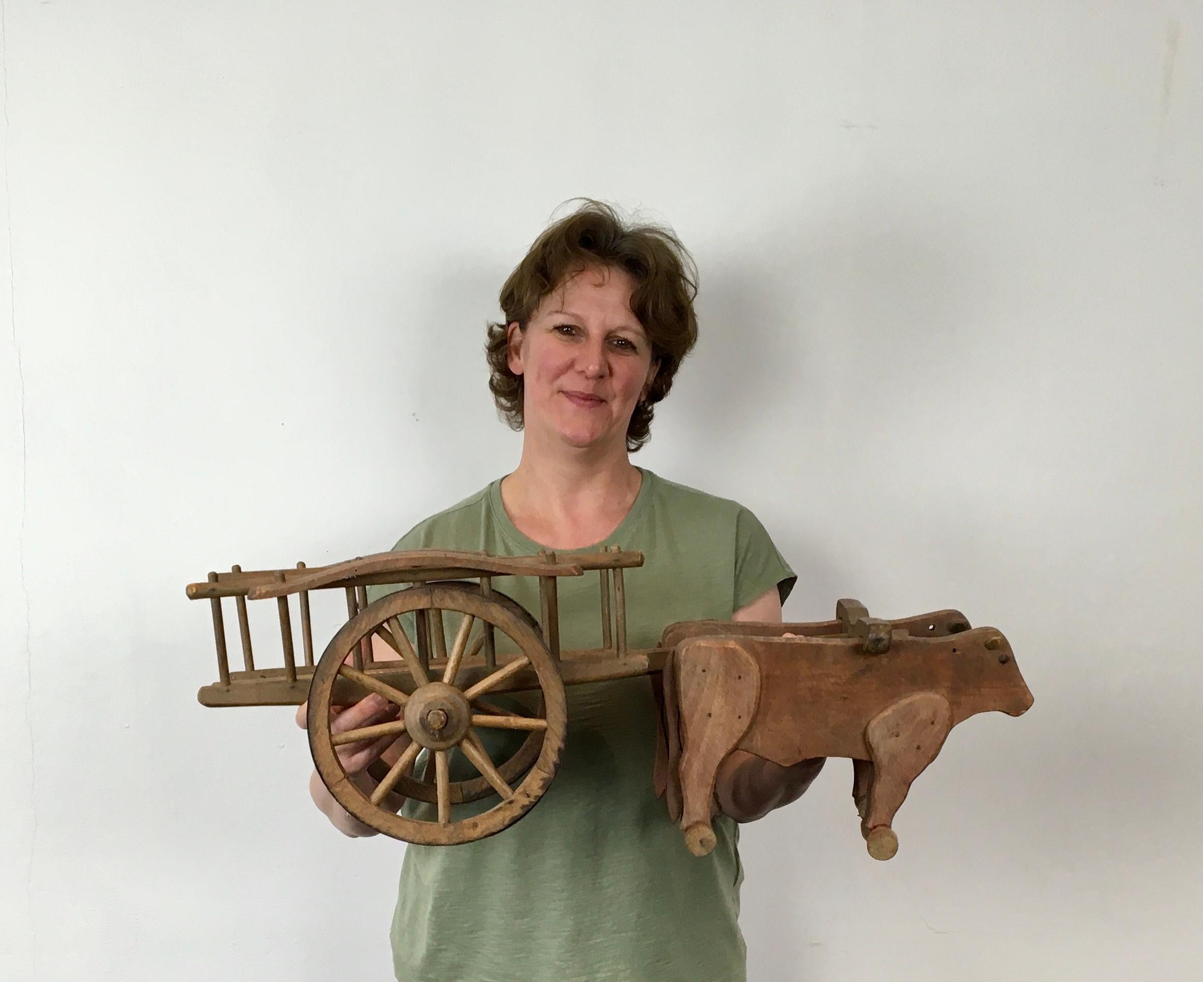 1940s wooden oxcart pull toy by Dejou, France. 
A vintage French large wooden toy by Dejou. 
This vintage toy is 29.52 inch or 75 cm long. 

Pull toy oxcart , farm wagon with two red oak Cows ,  Oxes ,  Bullocks.
Made by the French Company Dejou ,