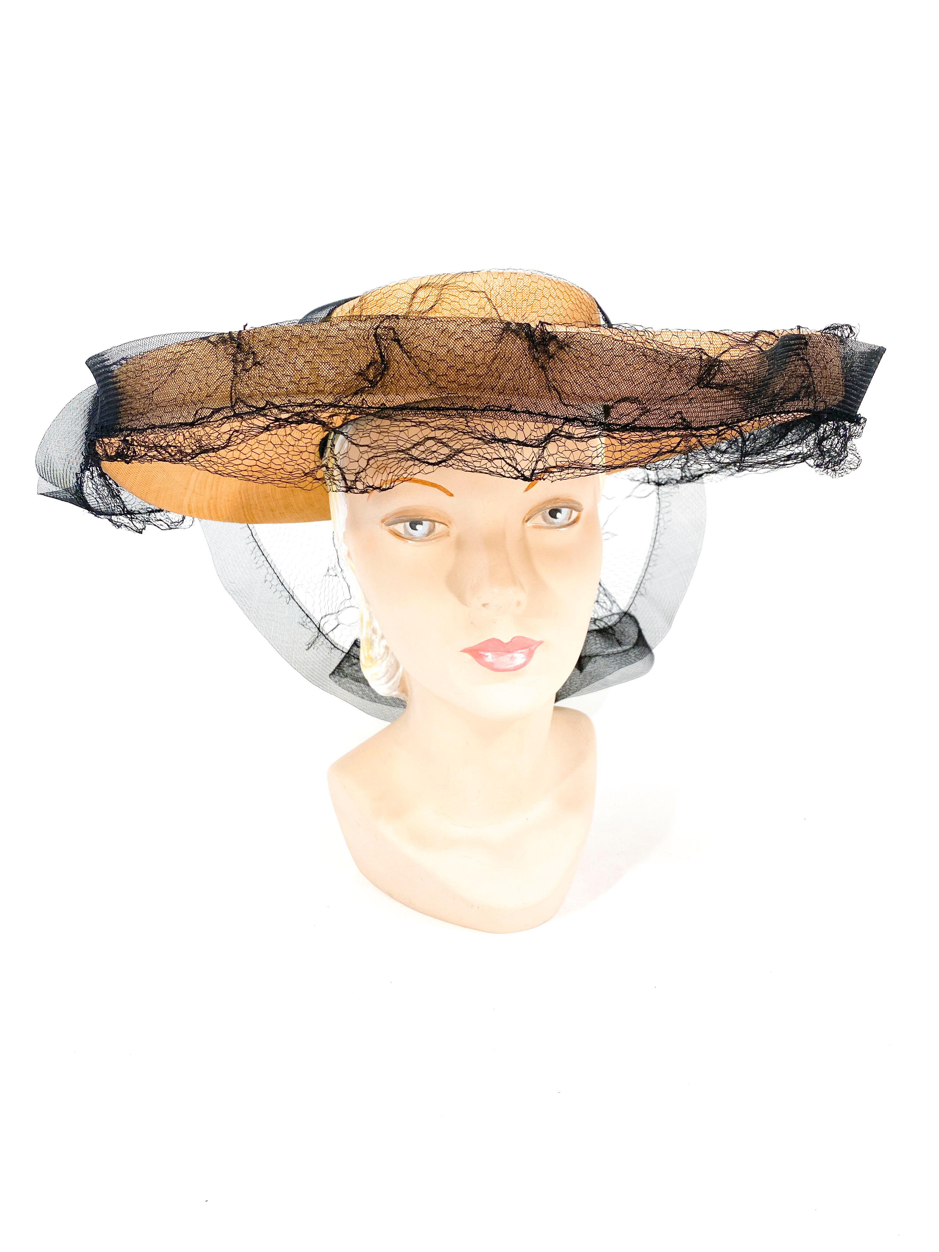 1940s panama woven picture hat with shallow crown, 1 inch fold up on the edge of the wide brim, and a draped spider web styled net trimmed in horse hair creating a fan in the back of the hat. 