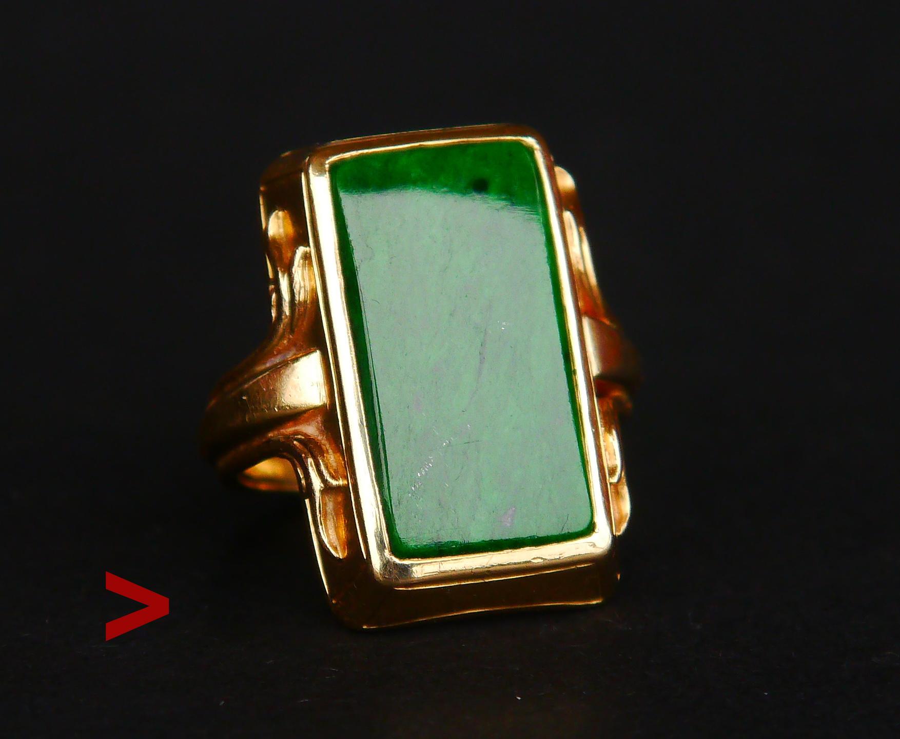 Nice Art Deco Ring with bezel set plate of vibrant deep Green high grade untreated Jade Stone, faceted baguette cut 18 mm x 9 mm / ca. 15 ct .

Swedish hallmarks of jewelry workshop ,Stockholm, 18K. Year marks P8 = handmade in 1941.

Crown is 22 mm