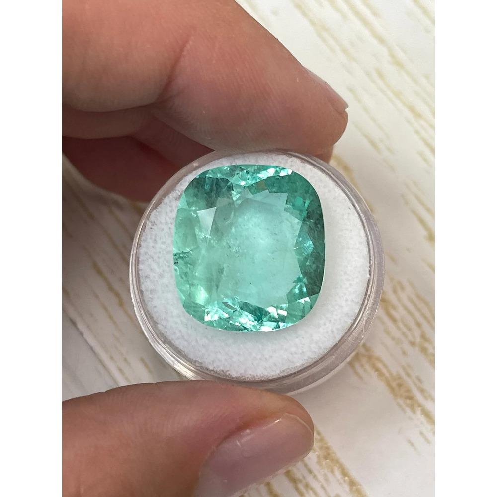Stone: Emerald
Weight: 19.41-carats
Shape: Cushion Cut
Clarity: Transparent
Luster: Very Good
Color: Pastel Bluish Green
Measurements: 18.89mm x 17.08mm x 9.20mm
Geographic Origin: Colombia
Treatment: Natural, Oiling

Comments: Due to their growth