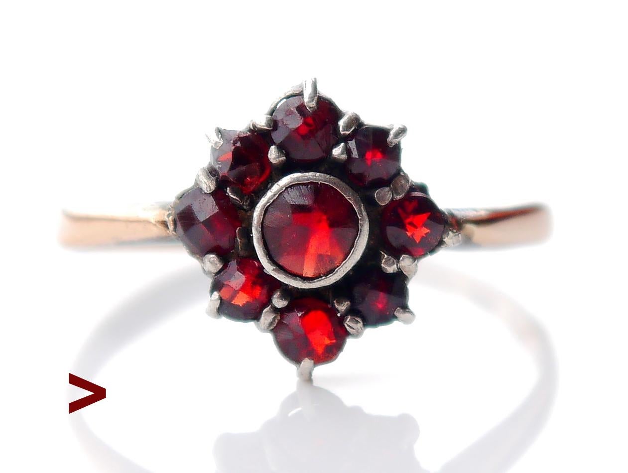 A Ring with Red Flower, since 1941.

Crown in Silver Ø 10 mm /3mm deep.
Band in solid 18K Rose Gold + 9 natural rose cut Red Bohemian Garnets of Pyrope variety with open backs.

This ring was made in Stockholm, Sweden in 1941 /year marks P8. 

Size: