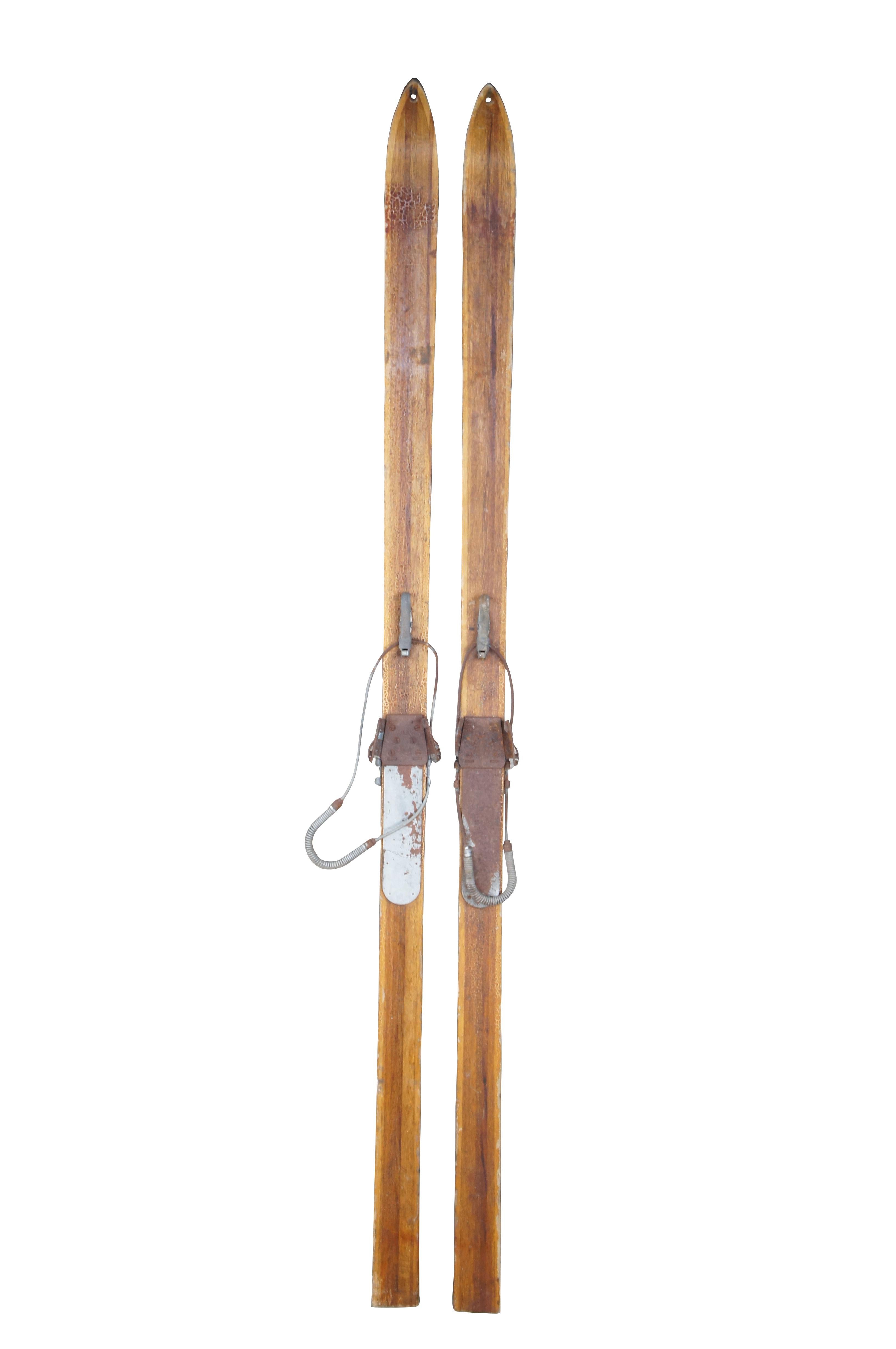 Antique RMC Paris Ski Company 10th mountain division military skis from WW II era, circa 1942.  Made of oak featuring traditional form with metal bindings.  Engraved with the name Bill Hardisty .  The holes in the tips were typical of military skis,