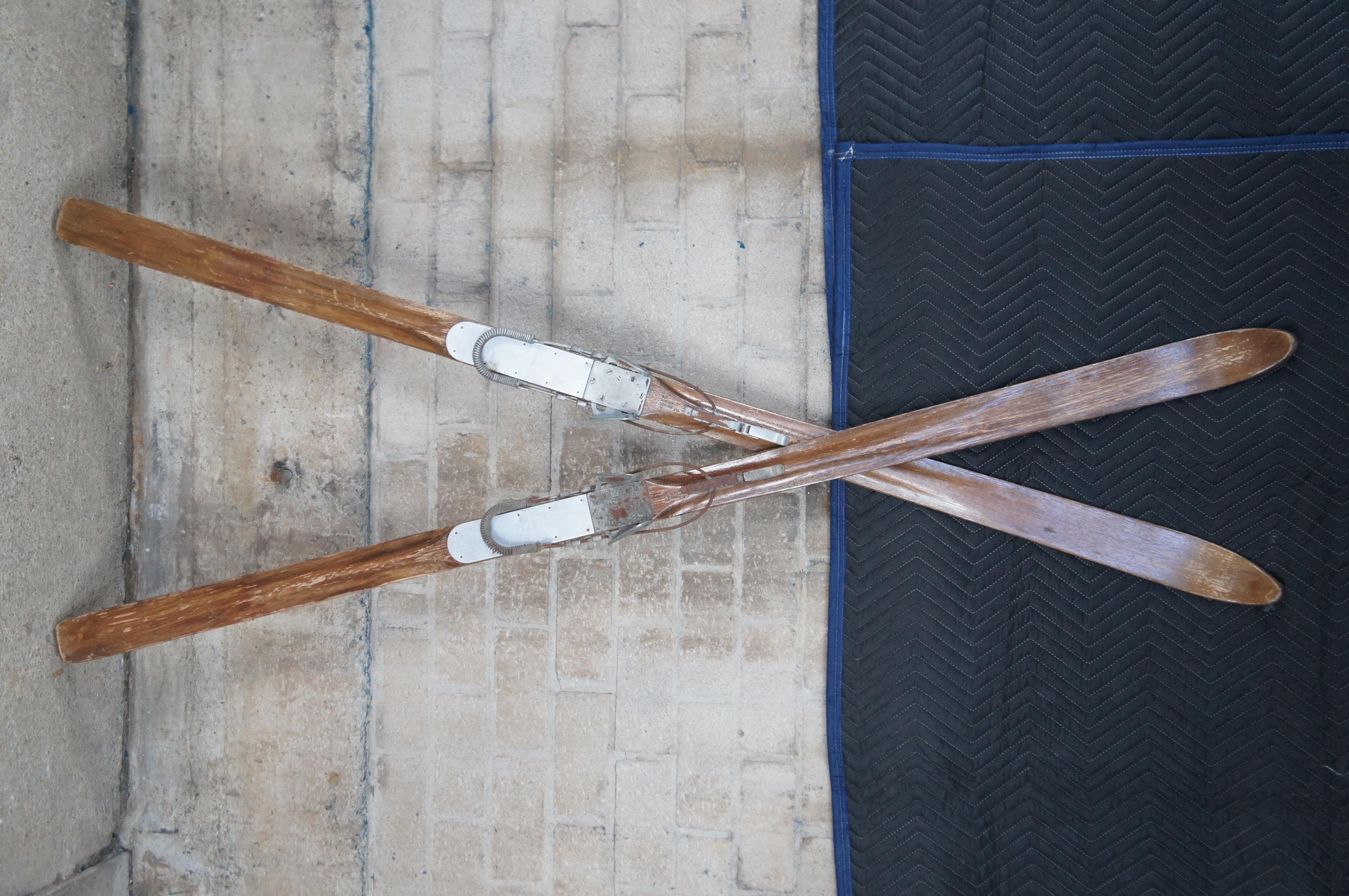 Antique Early American wood snow skis.  Made of oak featuring traditional form with metal bindings.  Circa 1935.