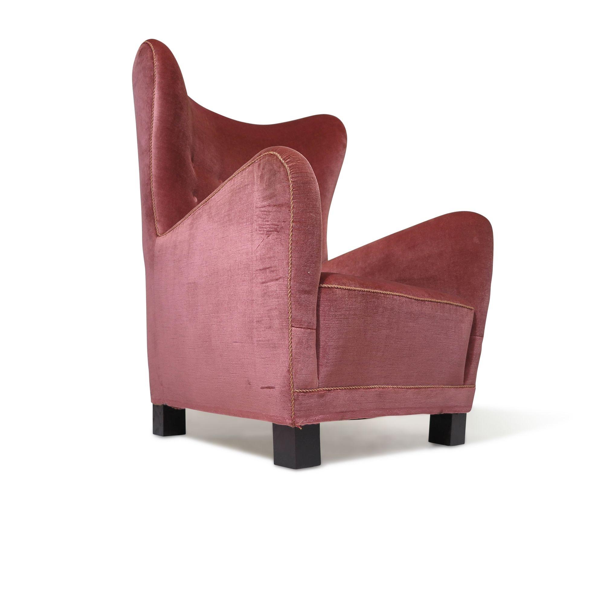Early Fritz Hansen high-back lounge chair, circa 1942, model #1672, features a solid wood frame, with eight-way hand tied copper coil springs and horsehair padding covered in the original pink mohair. This is a comfortable and stately chair, built