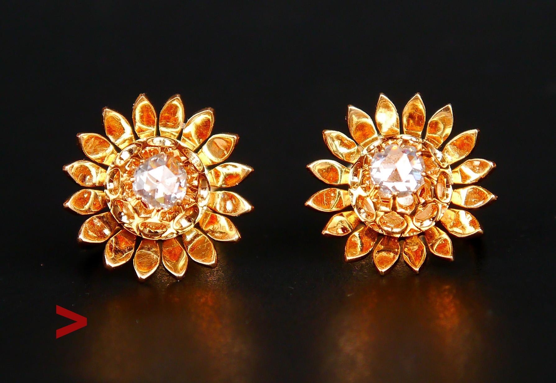 A pair of fine sparky flowers in solid 18K Yellow Gold. Each earring Ø 8.5 mm x 6 mm deep. Each has 16 delicate petals around openwork clusters with claw set rose cut Diamonds. Each stone measures Ø4 mm / ca. 0.28 ct each, color ca F,G /VS .

Hand -