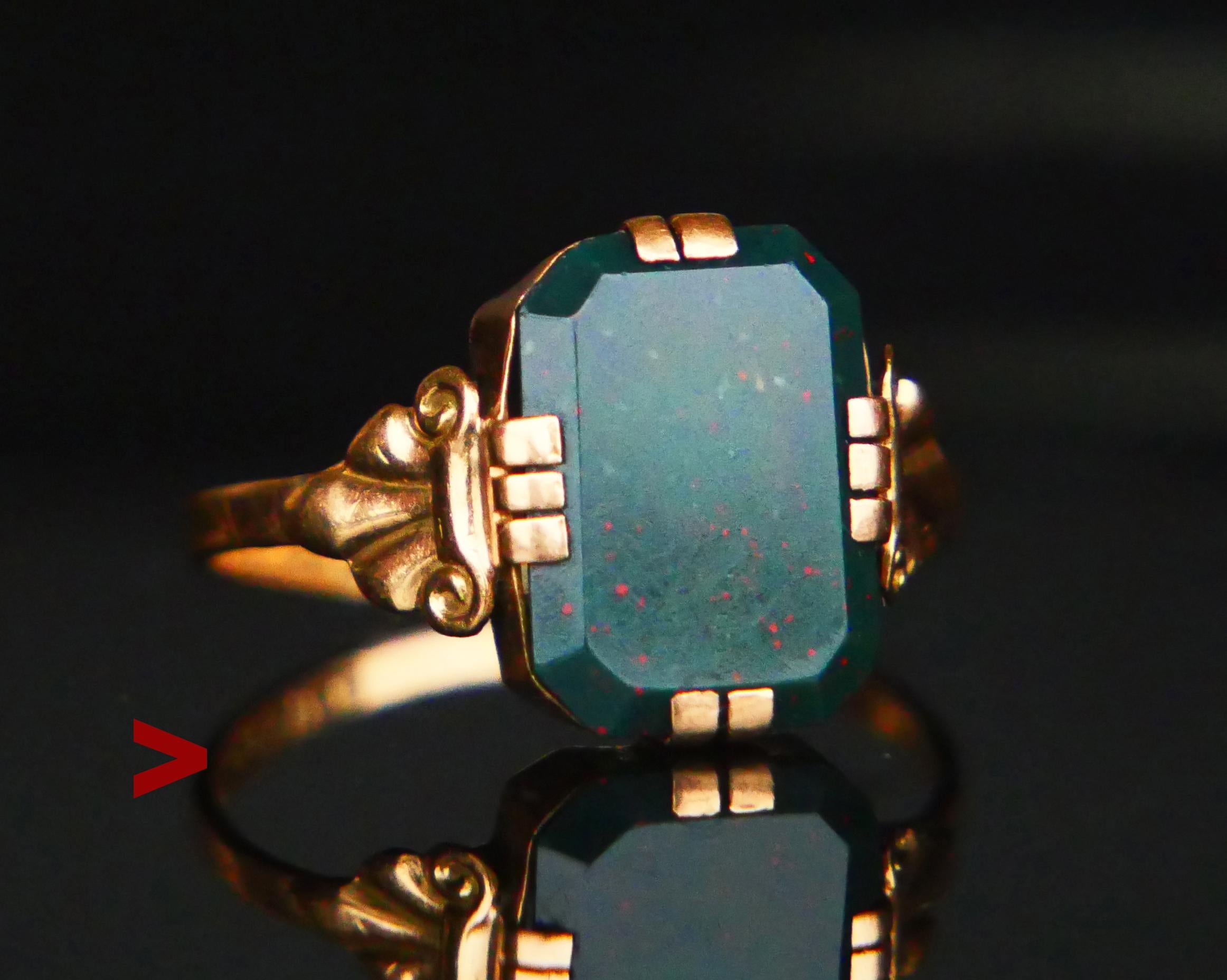 Unisex type Signet Ring in solid 18K Yellow Gold with carved shoulders and claw set Blood - stone, color is dark Green color with red dots, measures ca. 12 mm x 8.5 mm x 2.75 mm deep / ca. 6 ct. 

The band is 1.5 mm at the narrowest, hallmarked with
