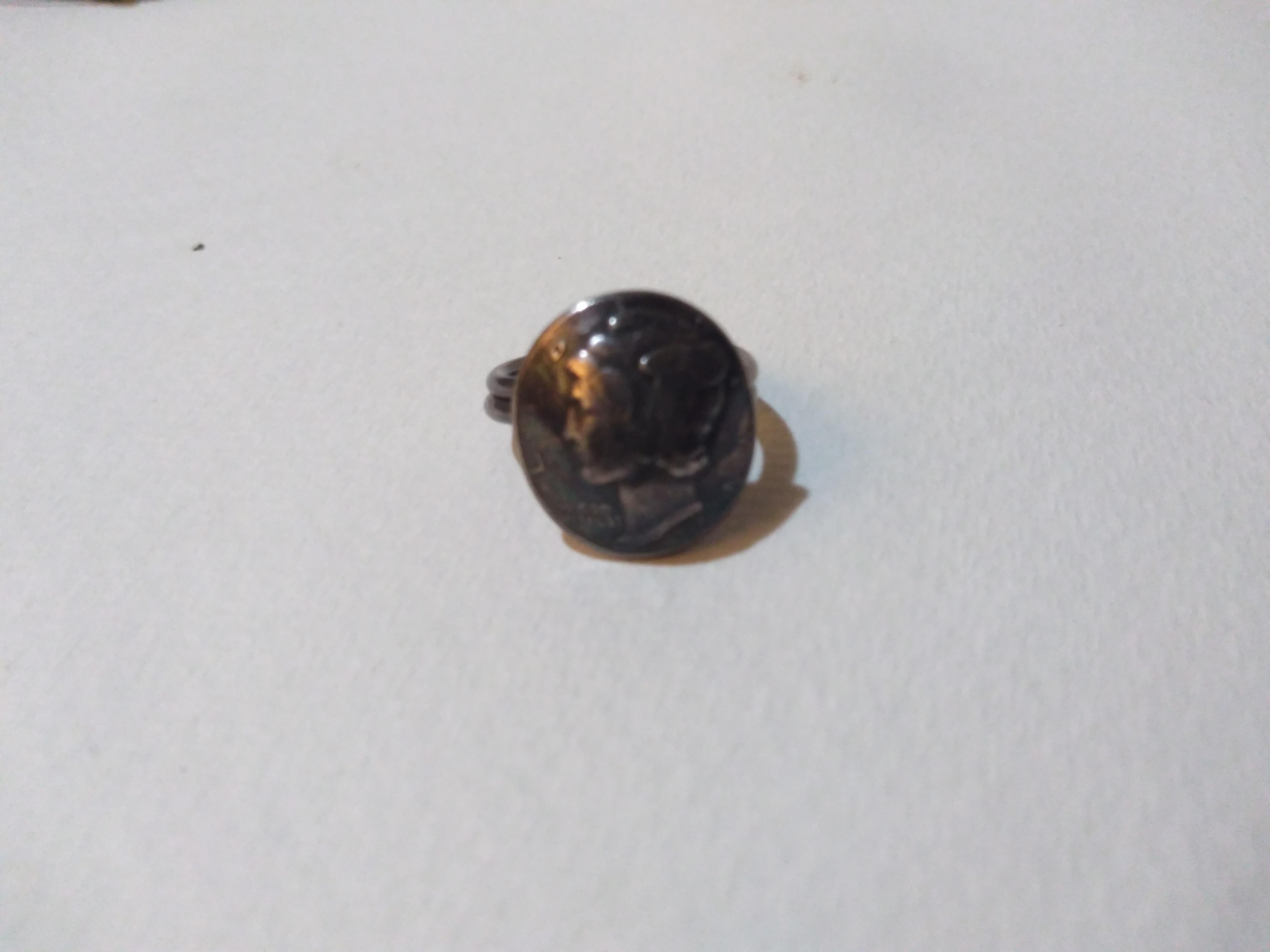 This is a size 4 coin silver ring made with an American 1944 Mercury Dime. It's done shaped and a work of art. The ring is made of coin silver and is nicely crafted.


Ready to wear.