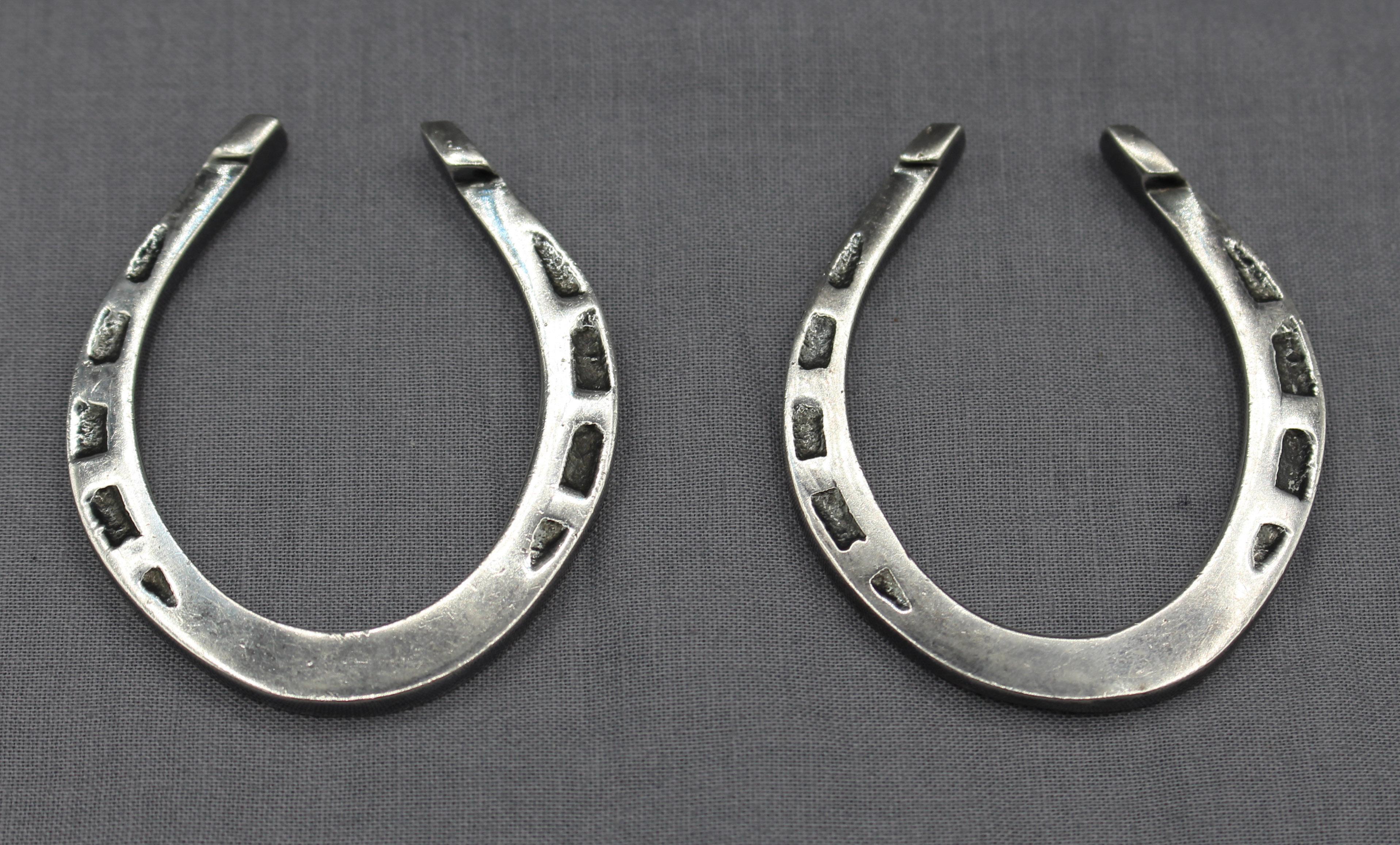 1944 pair of miniature sterling good luck horse shoes, Sheffield, England. Useful as paperweights or other decoration; most likely made by Harrison & Howson. 1.90 troy oz.
2 1/4