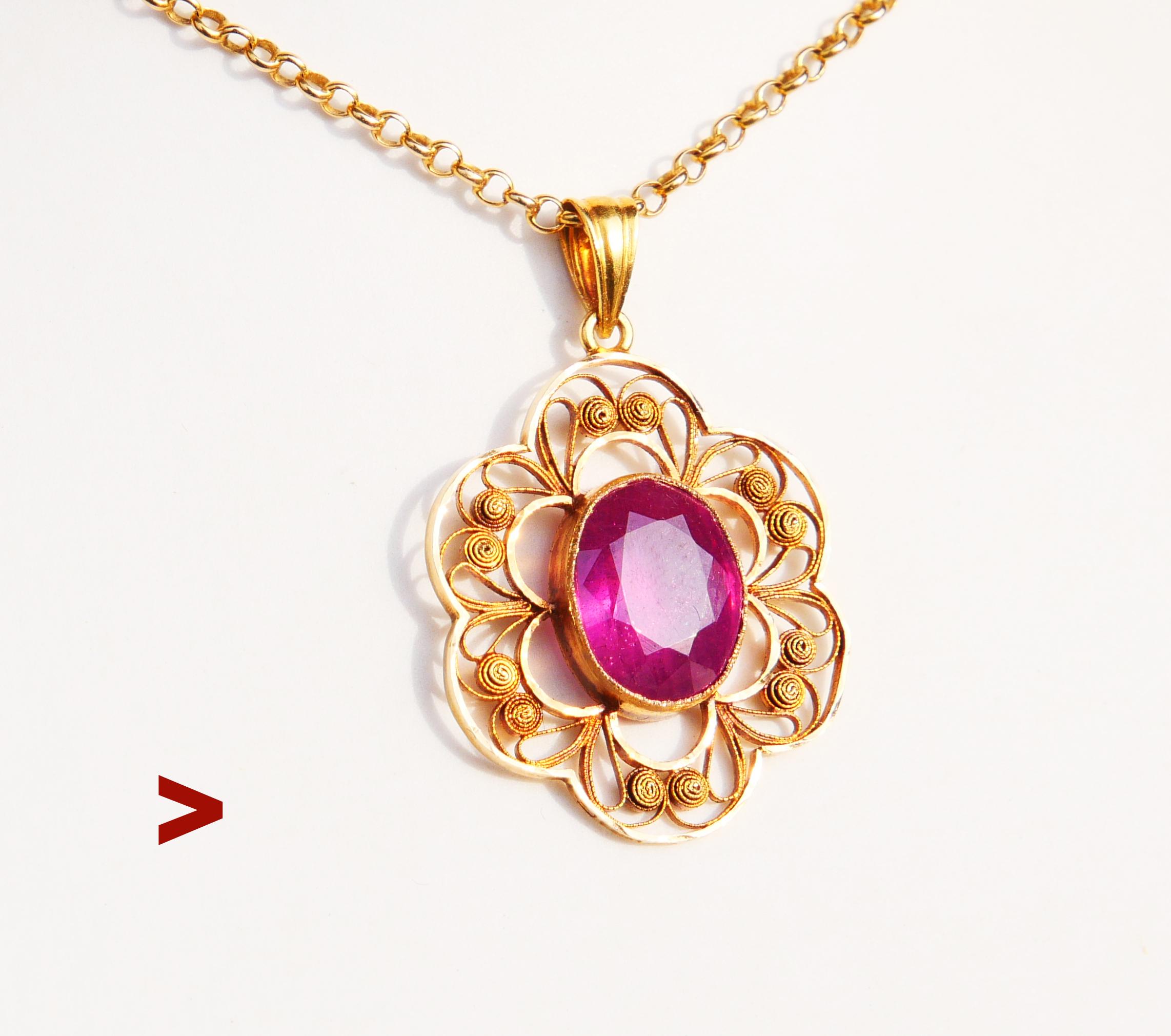 A pendant in solid 18K Yellow Gold , flower shaped with filigree ornaments around natural  Rosy Red Ruby 11 mm x 9 mm x 5.25 mm deep / ca.4ct. Stone is semitransparent with structure and inclusions typical for naturals.

Measures 33 mm long ( with