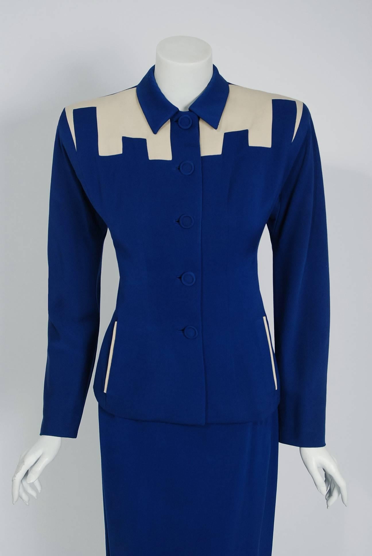 This stunning Fred A. Block Original two-piece ensemble, dating back to the mid 1940's, is fashioned in a stunning royal-blue and ivory lined gabardine. The construction itself is a masterpiece; deco block coloring that seems to have an almost