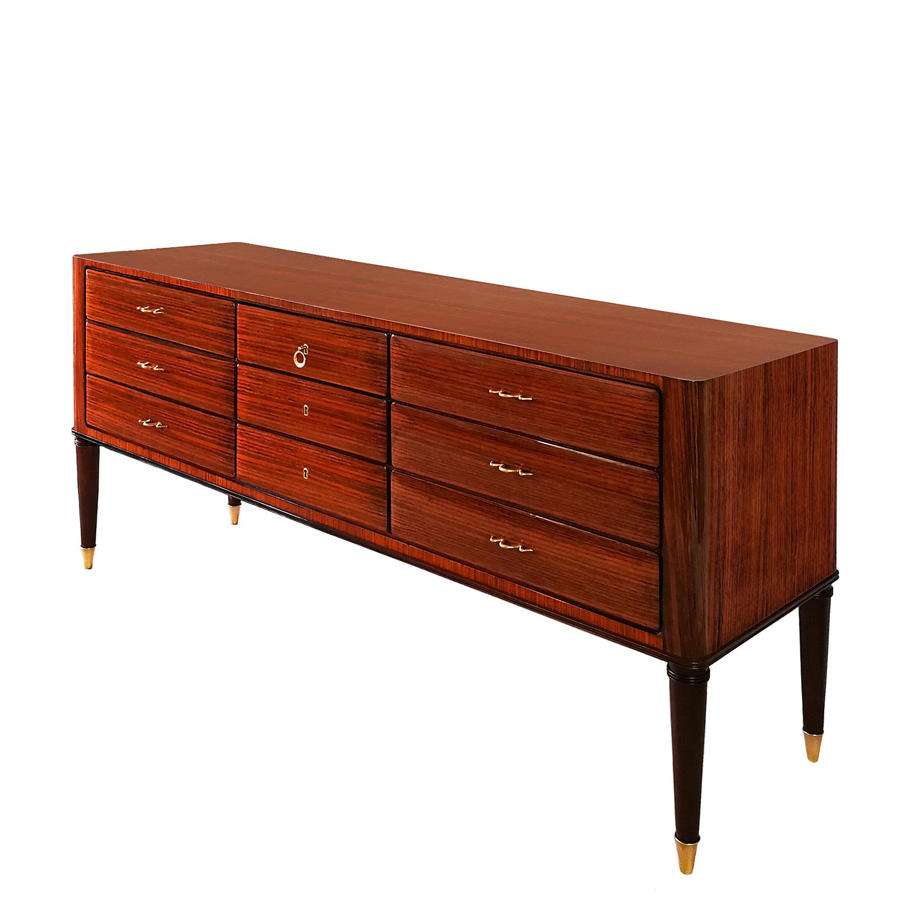 Grande commode con sei cassetti, in legno massiccio con impiallacciatura in legno zebrato, lucidatura francese. Piedi in mogano massiccio, maniglie e ferramenta in ottone lucido.

Italia, 1945 circa 

Misure: Profondità 49,5 cm - 52 cm con i