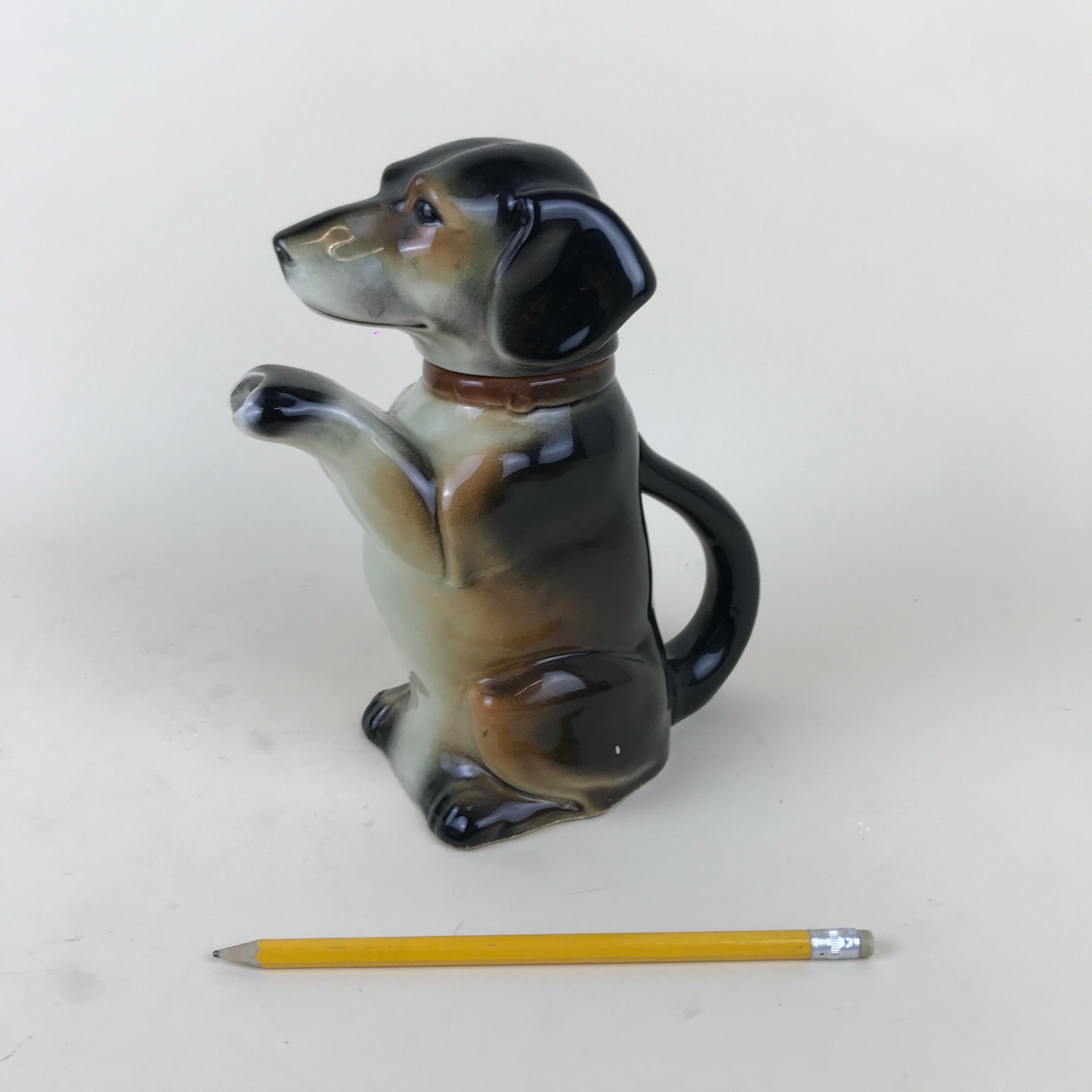 Art pottery dog figure teapot made by Erphila in Germany between 1945 and 1949.

This rare teapot is in majolica glazed. Even if the model 6703B was produced from the 1920s onwards we know a more precise production date from the bottom stamp 