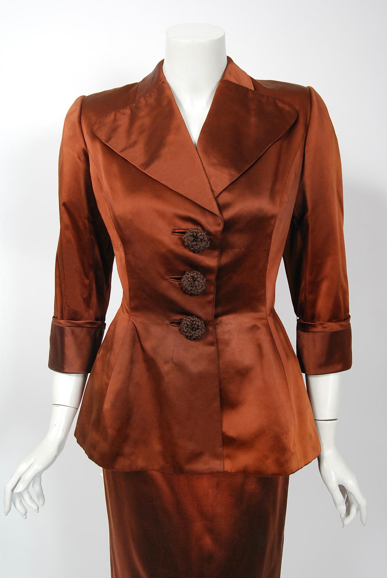 A breathtaking and extremely rare Balenciaga Haute-Couture copper silk satin sculpted cocktail suit from his 1946 fall-winter collection. Cristobal Balenciaga began his life's work in fashion at a very young age. It is fabled that the Marquesa de