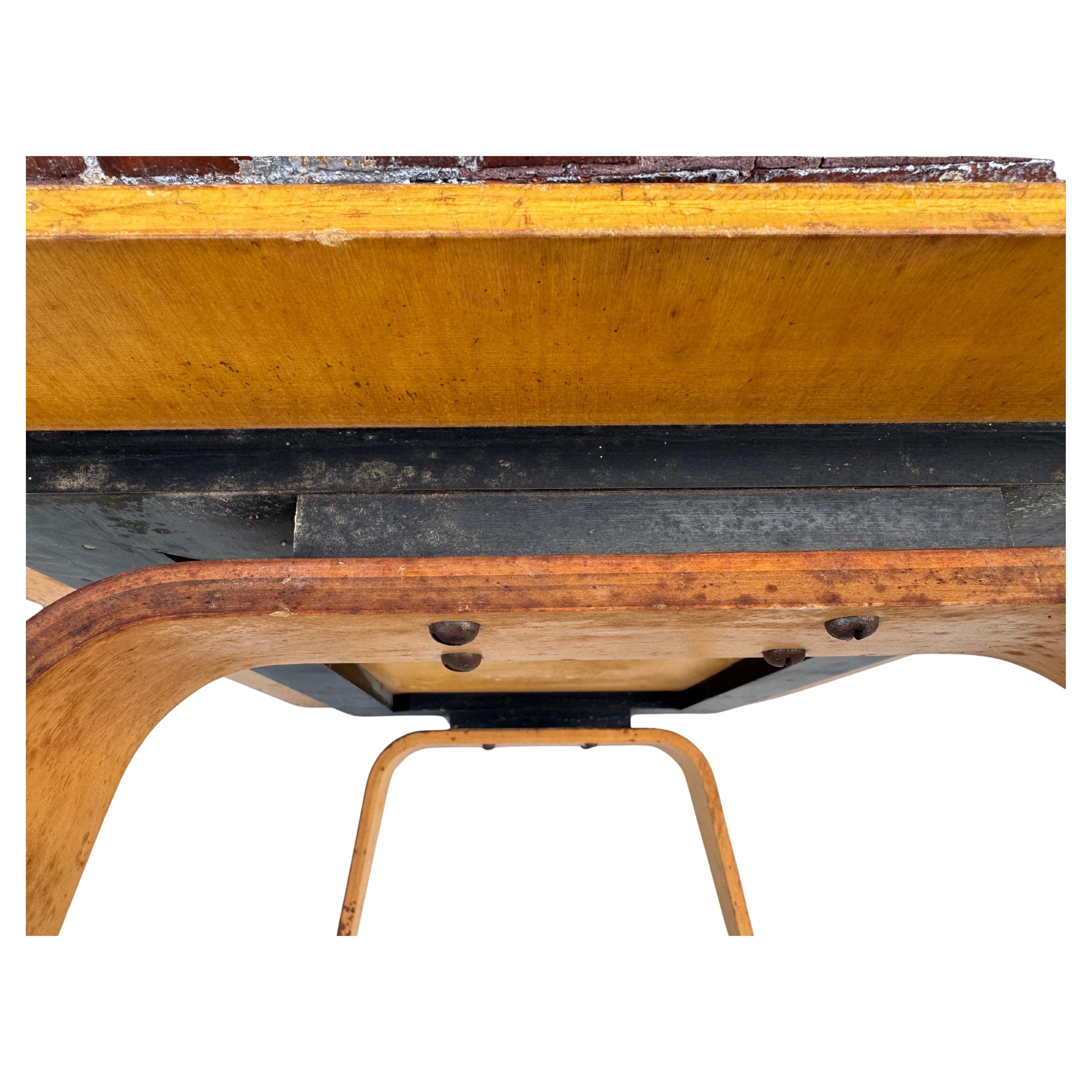 This is an original OTW Coffee Table, designed by Charles and Ray Eames and manufactured by the Evans Products Company in 1946. The acronym OTW stands for Oblong (O) Table (T) with a Wood (W) base. The piece is constructed from 5 thin layers of