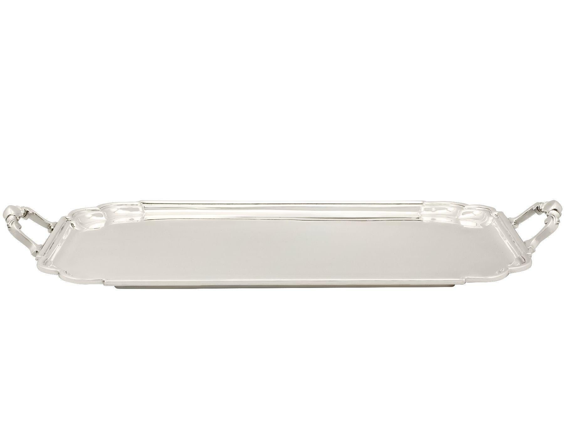 An exceptional, fine and impressive vintage George VI English sterling silver Art Deco style two handled tea tray; an addition to our silver tray collection.

This exceptional vintage sterling silver tray has a rectangular rounded form with