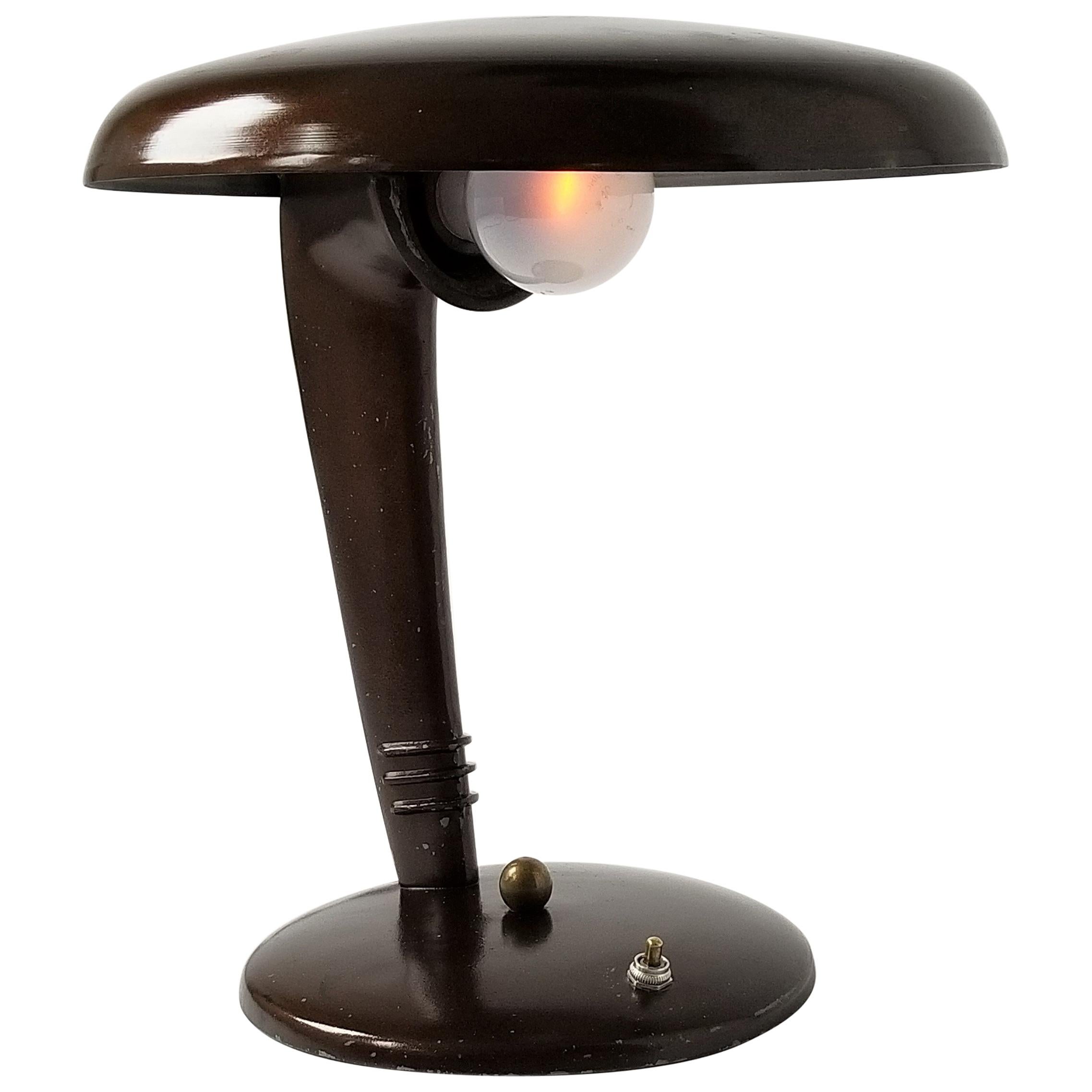 Iconic streamline table lamp made of enameled casted and spun steel. 

In a dark brown cooperish tone.

Regular E26 light bulb rated at 100 watt.