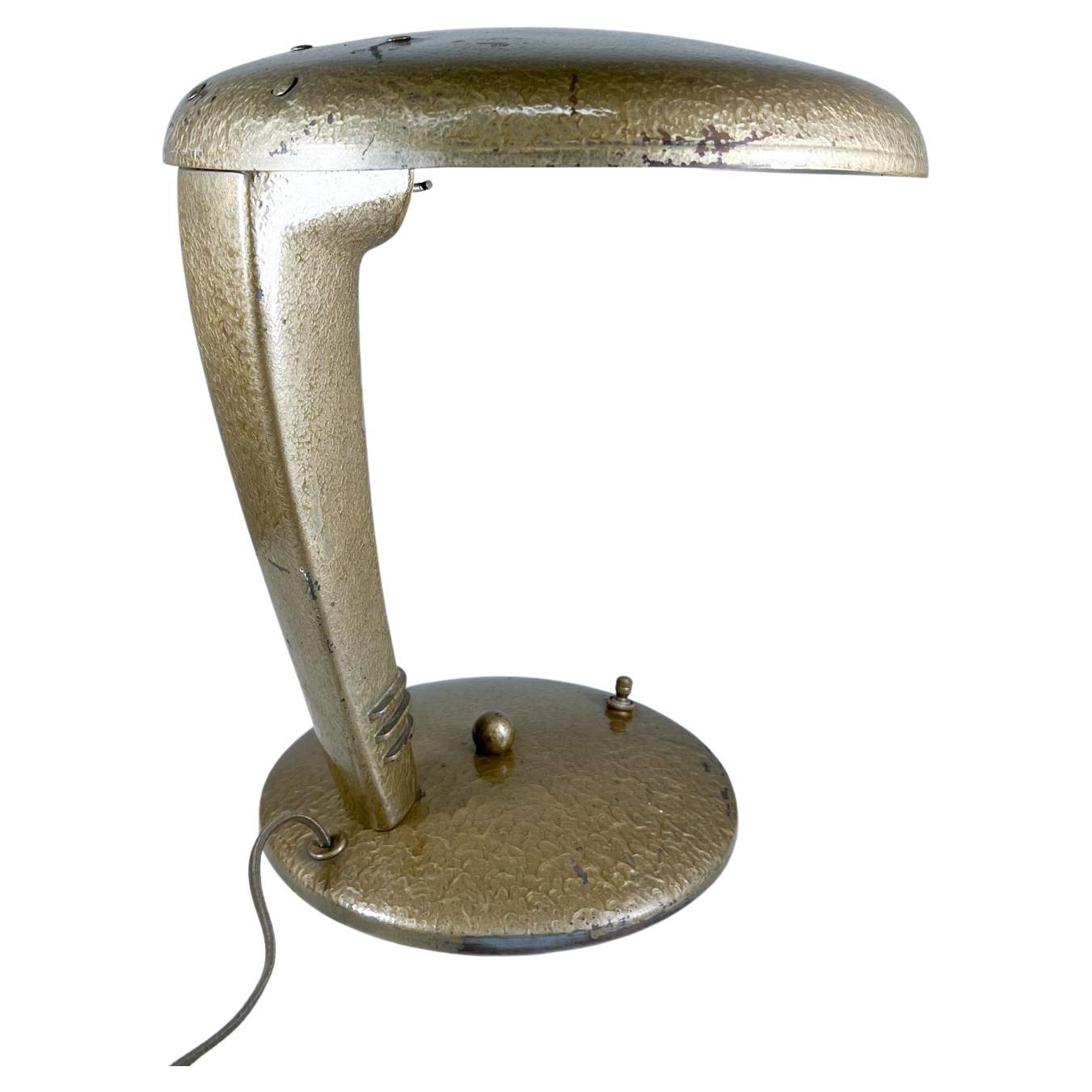 1947 Antiqued gold cobra lamp by Jean Otis Reinecke for Faries MFG
Measures: 12 tall x 11.25 deep x 10.75 wide
Robert Fairies MFG- Jean Ottis. Reinecke 1947
Norman Bel Geddes Era
Brass copper metal 
Unrestored original vintage condition.
See