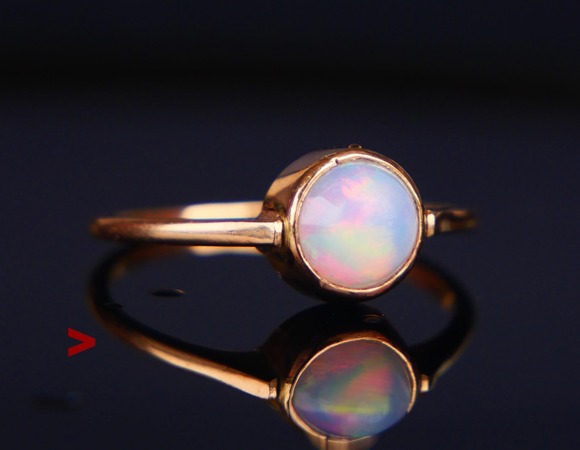 Vintage Ring decorated with bezel set round cabochon of natural Opal stone Ø 6.5 x 4.5 mm, ca. 1.25ct . Stone with natural flow inside, shows multicolored effects often differently in various light conditions. 
 
Crown is 6 mm high.

Made in Sweden,