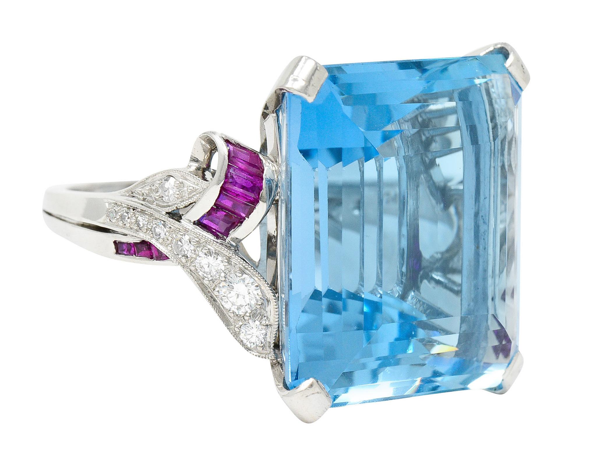 Featuring an emerald cut aquamarine weighing approximately 32.82 carats

Transparent with vivid and uniform greenish blue Santa Maria color

Basket set by wide prongs and flanked by decoratively scrolled shoulders

Channel set with calibrè cut