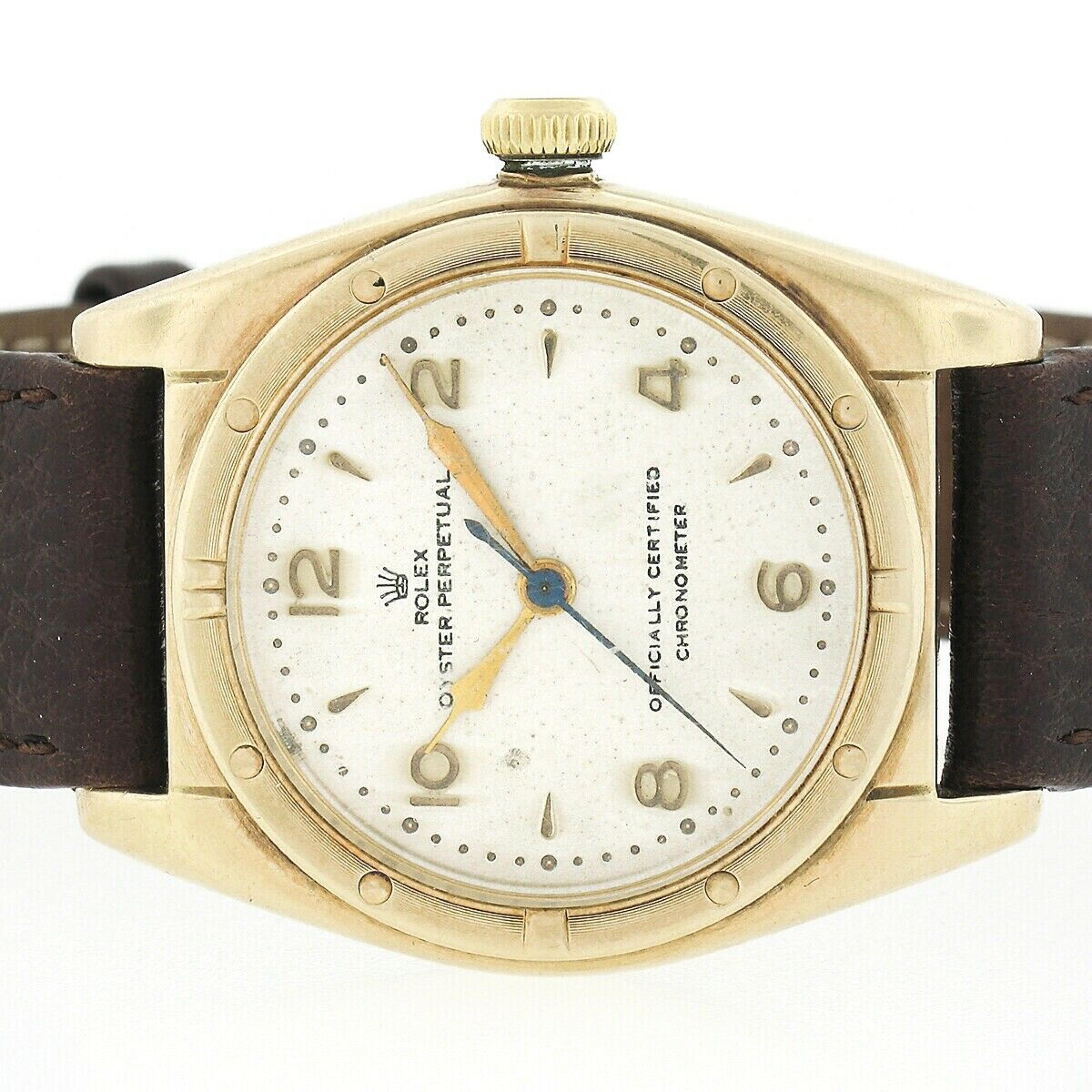 This gorgeous, vintage, Rolex Oyster Perpetual wrist watch is mounted in a 32mm case crafted in solid 14k yellow gold back in 1948. The watch features a self winding automatic Rolex movement that winds, sets, and runs smoothly. This watch has its