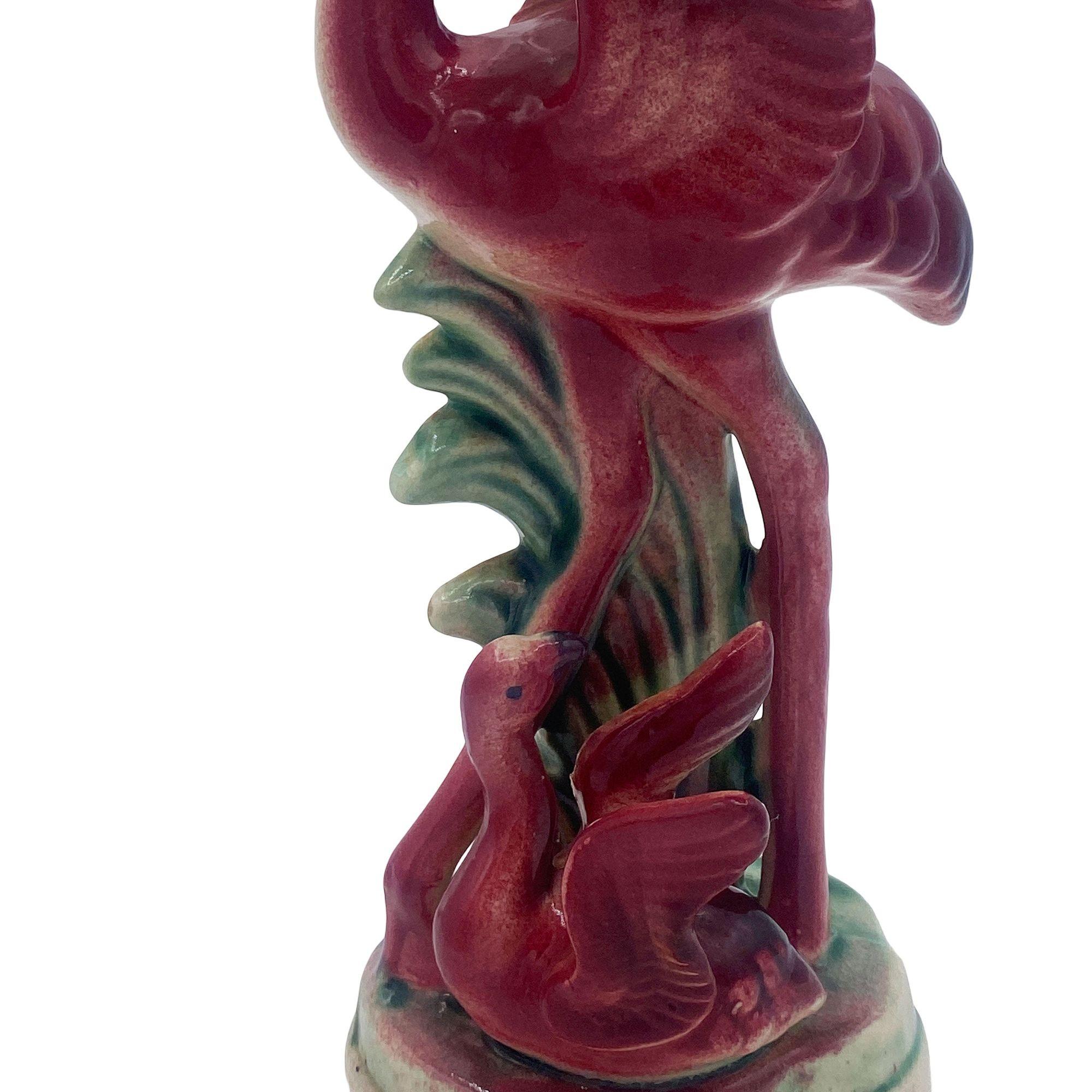 Mid-century pink and green ceramic open-wing flamingo tabletop Florida pottery statue by Souvenir of Miami. The statue features a beautifully detailed pink flamingo mother with her child. It comes in a gloss finish that highlights the rich pinks,