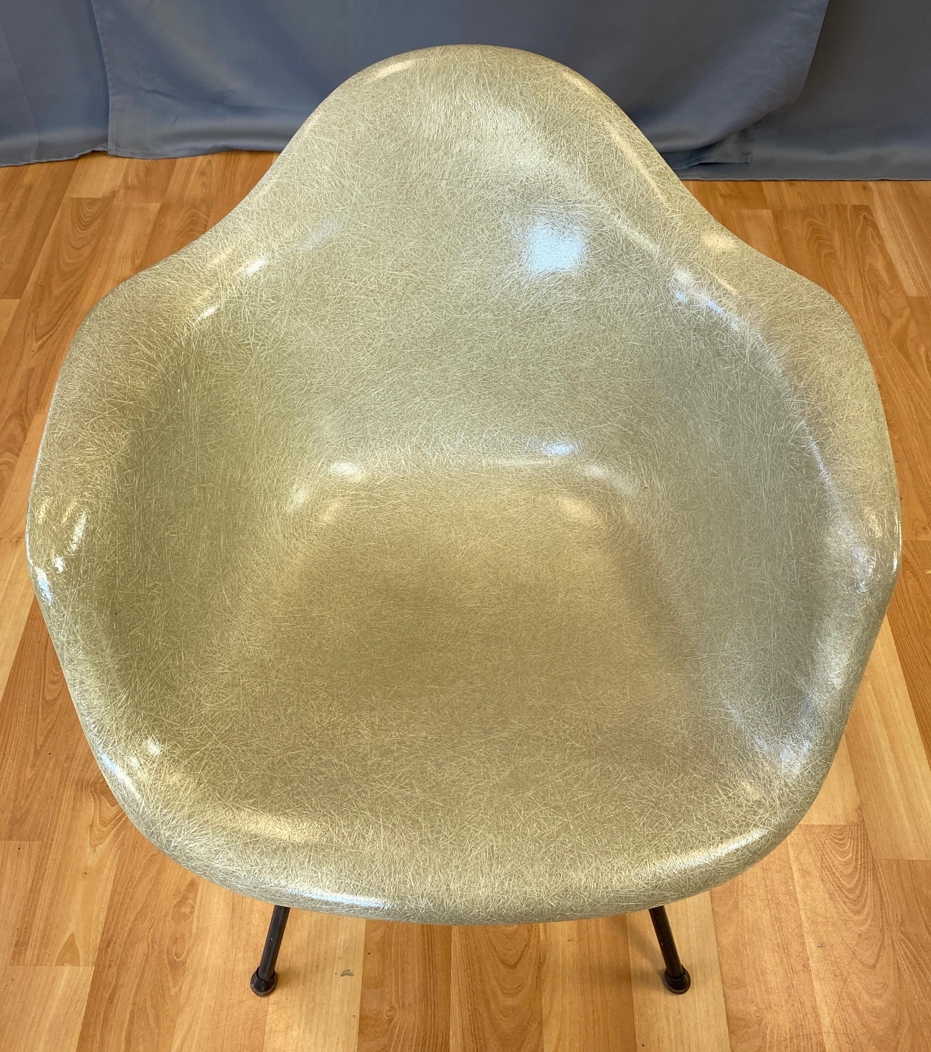 Offered here is a Charles Eames designed rope edge fiberglass shell armchair for Herman Miller, color is Greige.
This is a first year, 1949-1950 production of the chair. This model was entered into Museum of Modern Art of New York's International