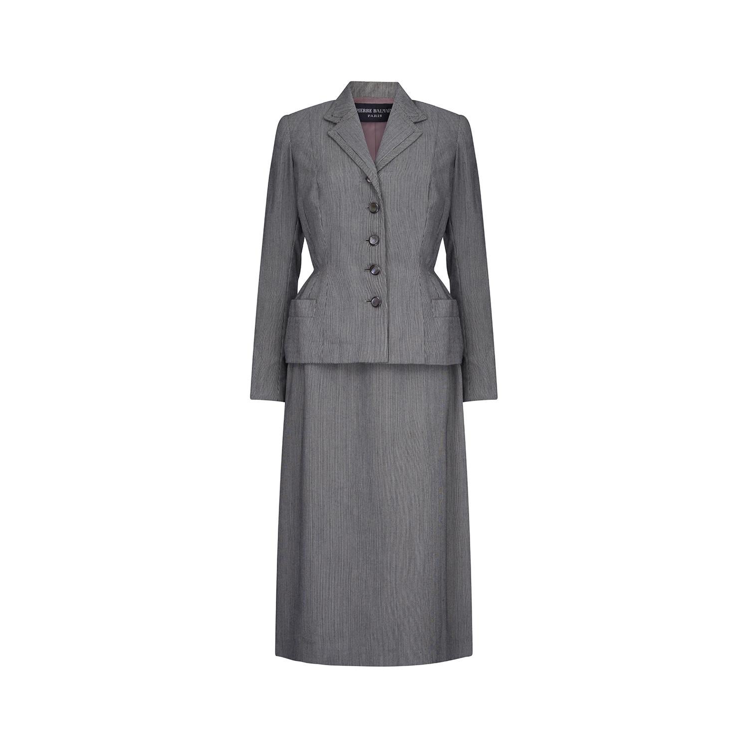 Fine and rare Pierre Balmain haute couture grey bar jacket and skirt suit attributed to the autumn / winter 1949 collection.  The jacket is tailored in a beautiful pinstripe wool with five iridescent buttons running down the middle front of the