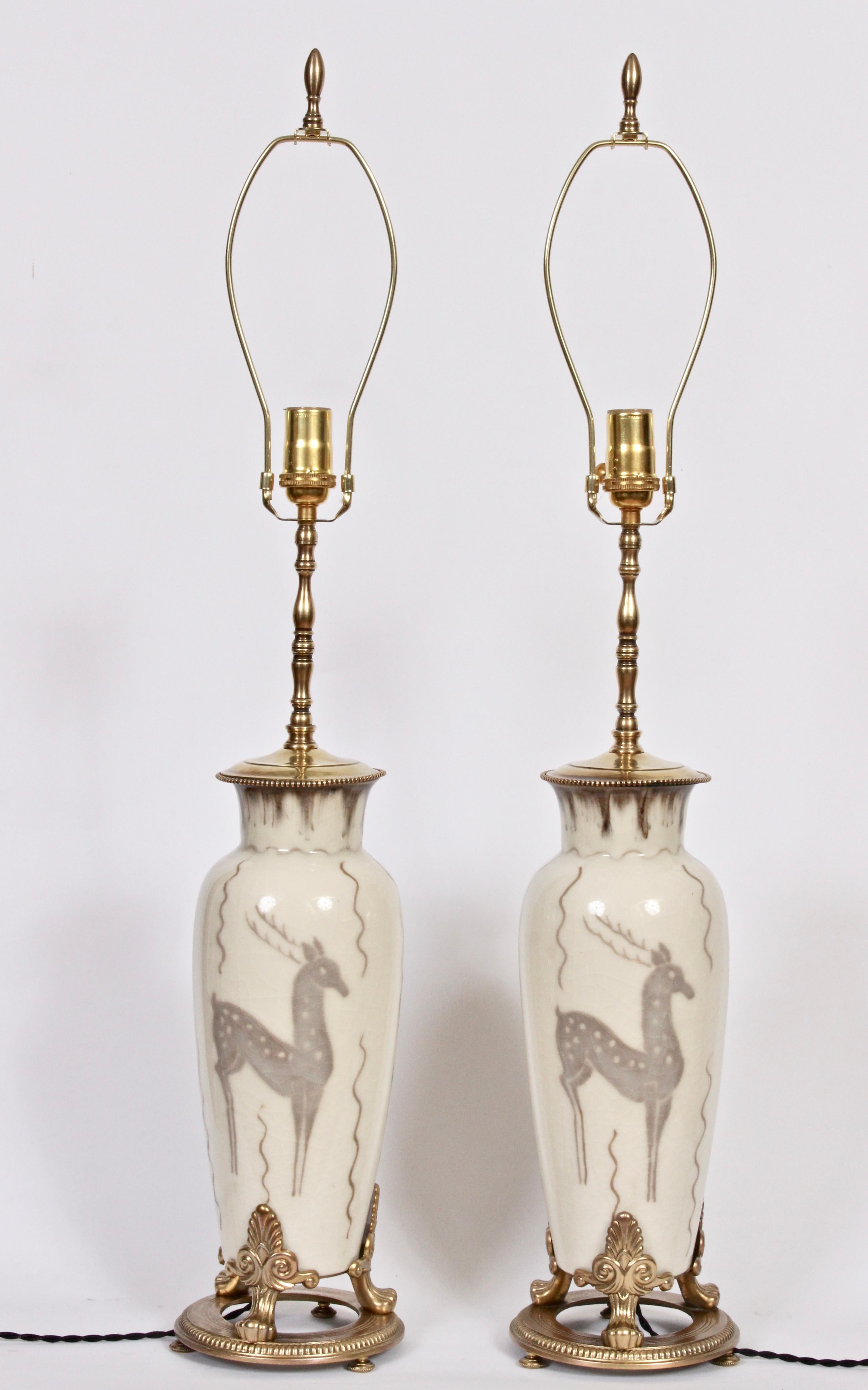 Majestic pair of Rookwood Pottery Ceramic Table Lamps hand painted by artist Loretta Holtkamp, 1949. Featuring a tapered form with flared rim, decorative Brass neck, overall crackle glaze with brown drip glaze at neck, neutral coloration,