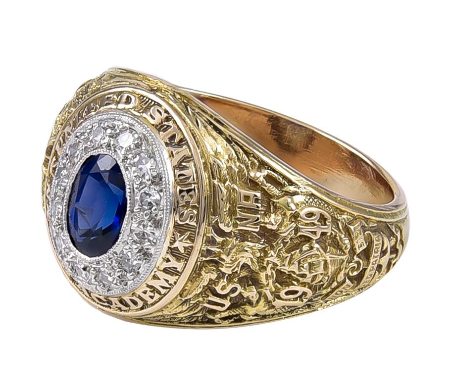 Superb United States Naval Academy sweetheart ring.  Made and signed by BAILEY BANKS & BIDDLE.  14K yellow gold.  There is a center faceted sapphire,  surrounded by shimmering diamonds set in platinum.  Fine embossed and applied lettering on the