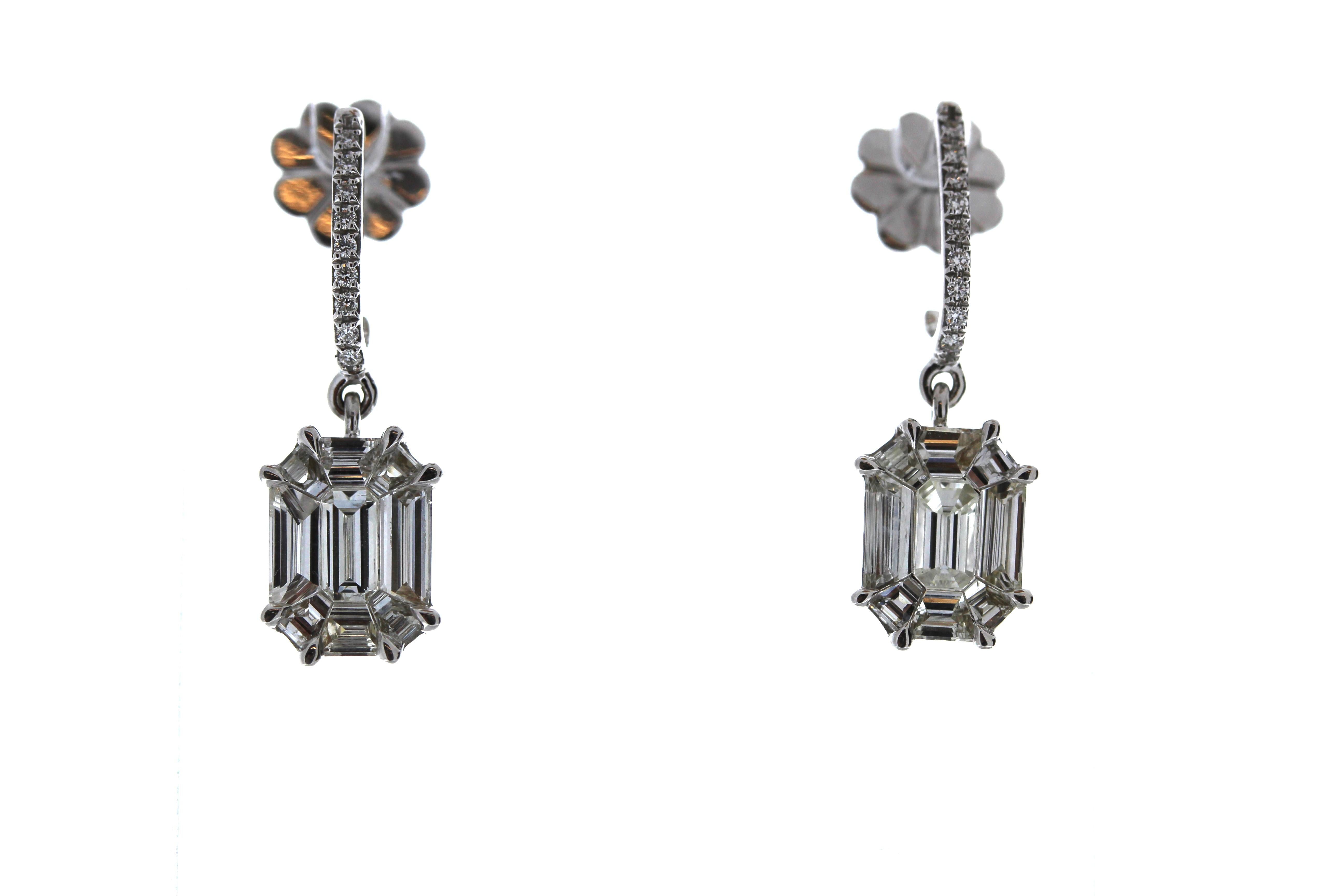 These luxurious 18k White Gold earrings feature multiple mixed cut diamonds that total up to 1.97CTW. The mixed cut diamonds give the illusion that it is a whole diamond.