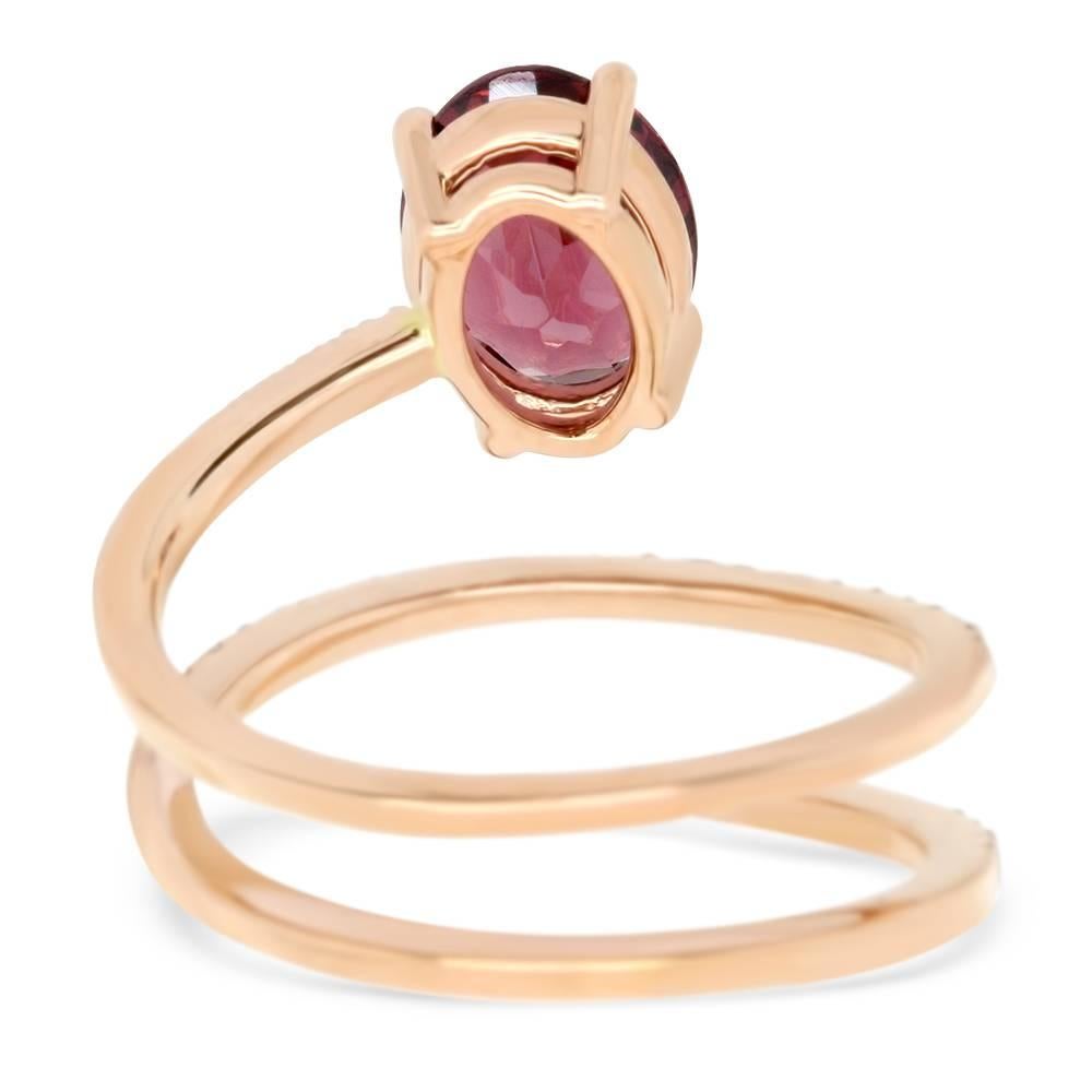 Material: 14k Rose Gold 
Center Stone Details: 1.95 Carat Oval Cut Rhodolite Garnet. Measuring 9 x 7 mm.
Mounting Diamond Details: 42 Round White Diamonds at 0.28 Carats. Measuring 1.15 mm. Clarity: SI / Color: H-I
Ring Size: Size 6.5 (can be