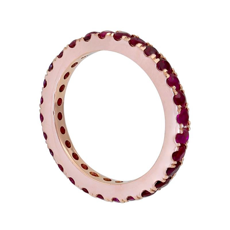 A color-rich wedding band showcasing a row of rubies set in a polished 18k rose gold mounting.
Rubies weigh 1.95 carats total. Can be used as a right hand or fashion ring as well.
Size 6.5 US. 

Style is available for any size finger. Price varies