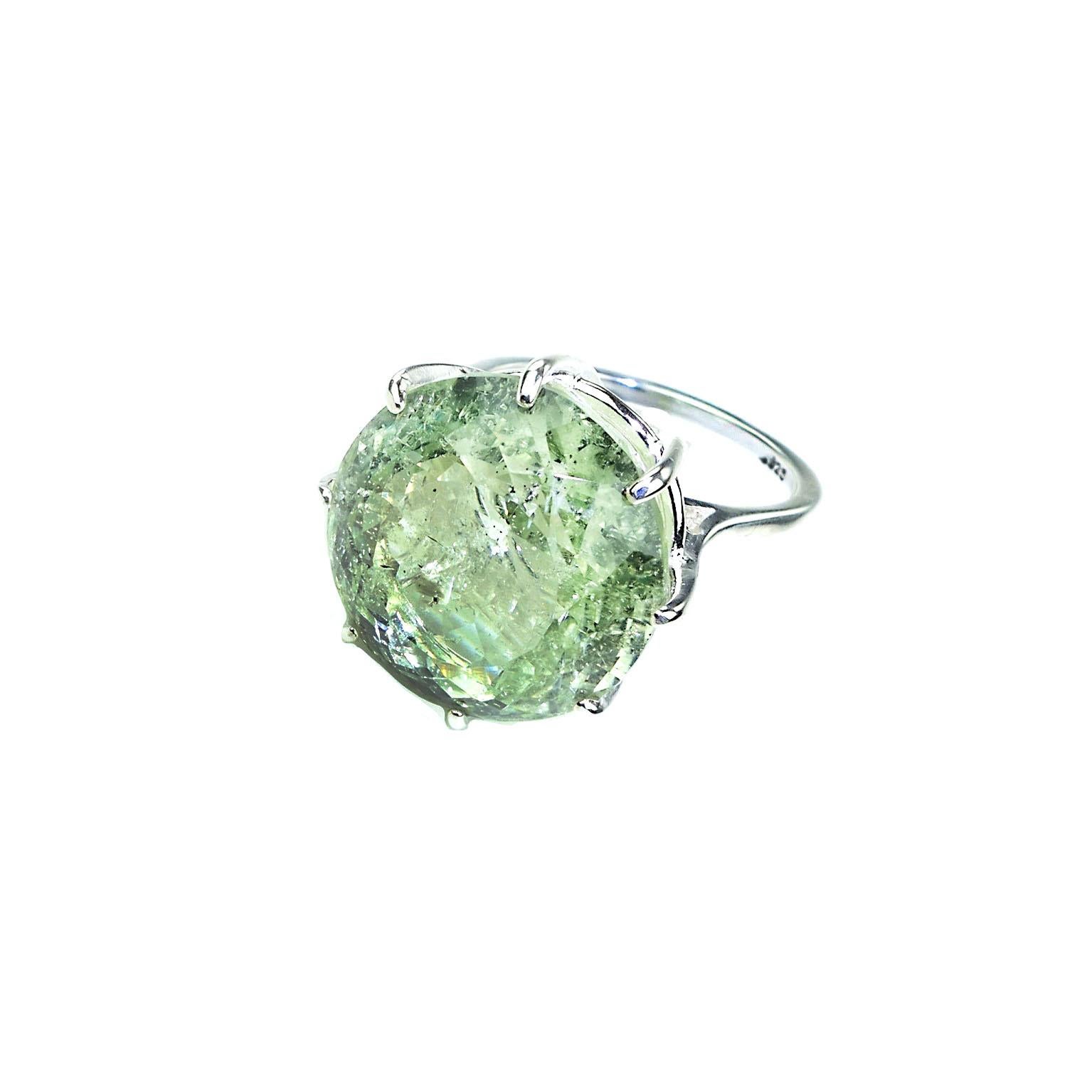 Custom made round green Beryl of 19.50 carats in a Sterling Silver ring. This big round Cocktail ring really makes a statement.  The sparkling stunner has all the natural inclusions common to beryls, which in this case, help to reflect the light