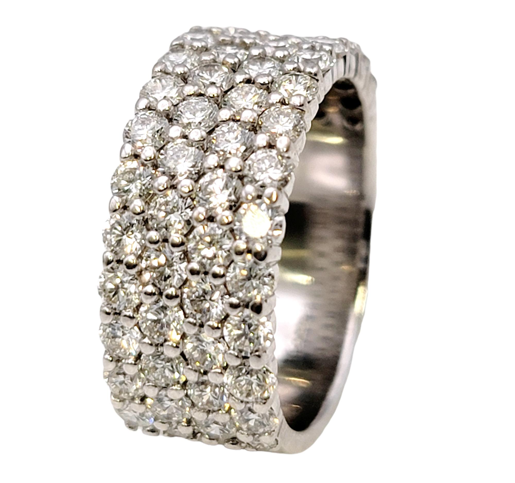 Ring size: 6.5

Stunningly sparkly diamond semi-eternity band ring. This gorgeous ring features 1.95 carats of bright, icy white pave diamonds set in 4 rows in a highly polished 18 karat white gold setting. The white gold really enhances the white