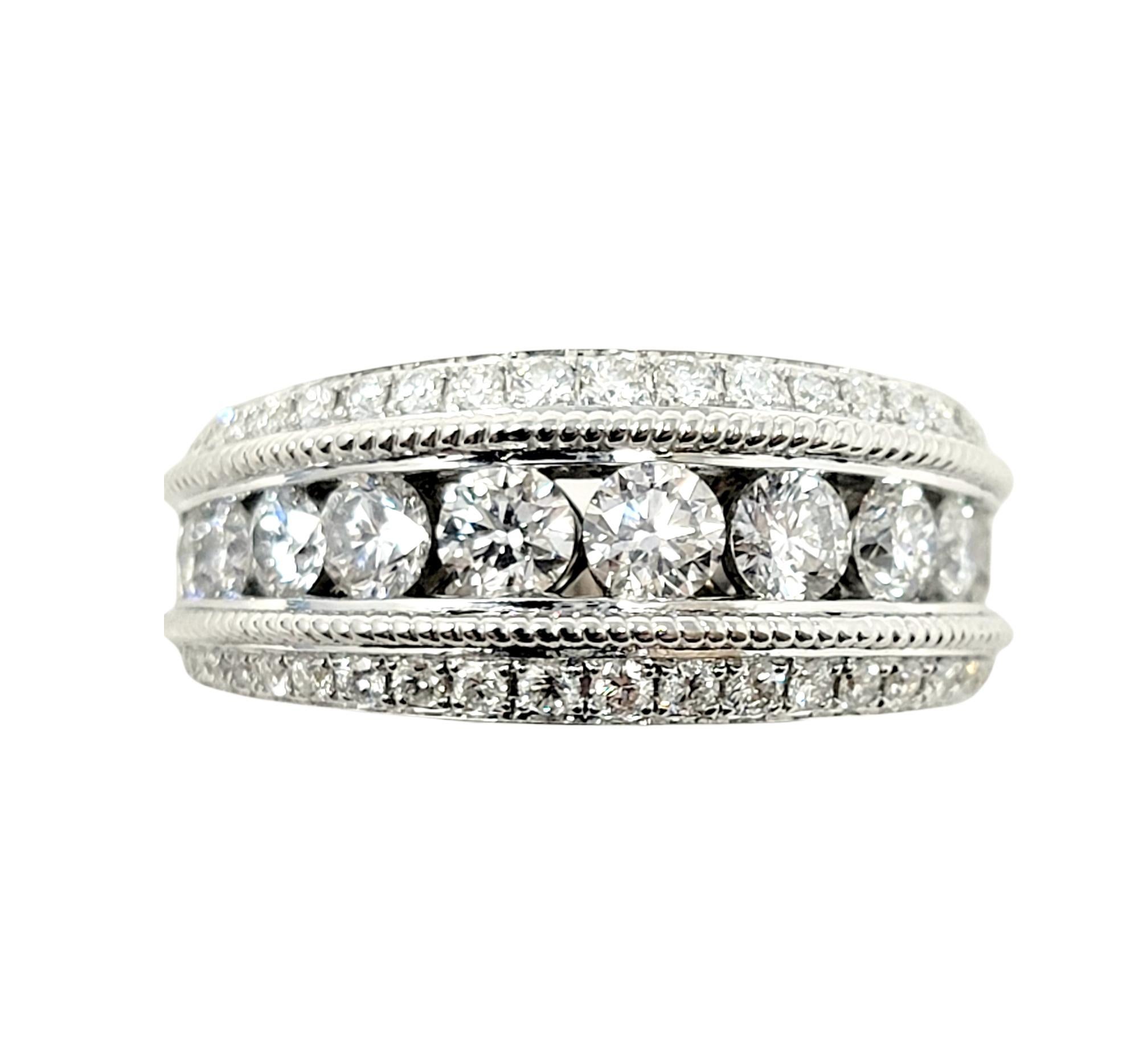 Ring size: 8.75

Absolutely gorgeous graduated diamond band ring with 3 row design. This sparkling beauty features 11 icy white round brilliant diamonds channel set in a single row down the center of the piece. Bordering the center diamonds are 2