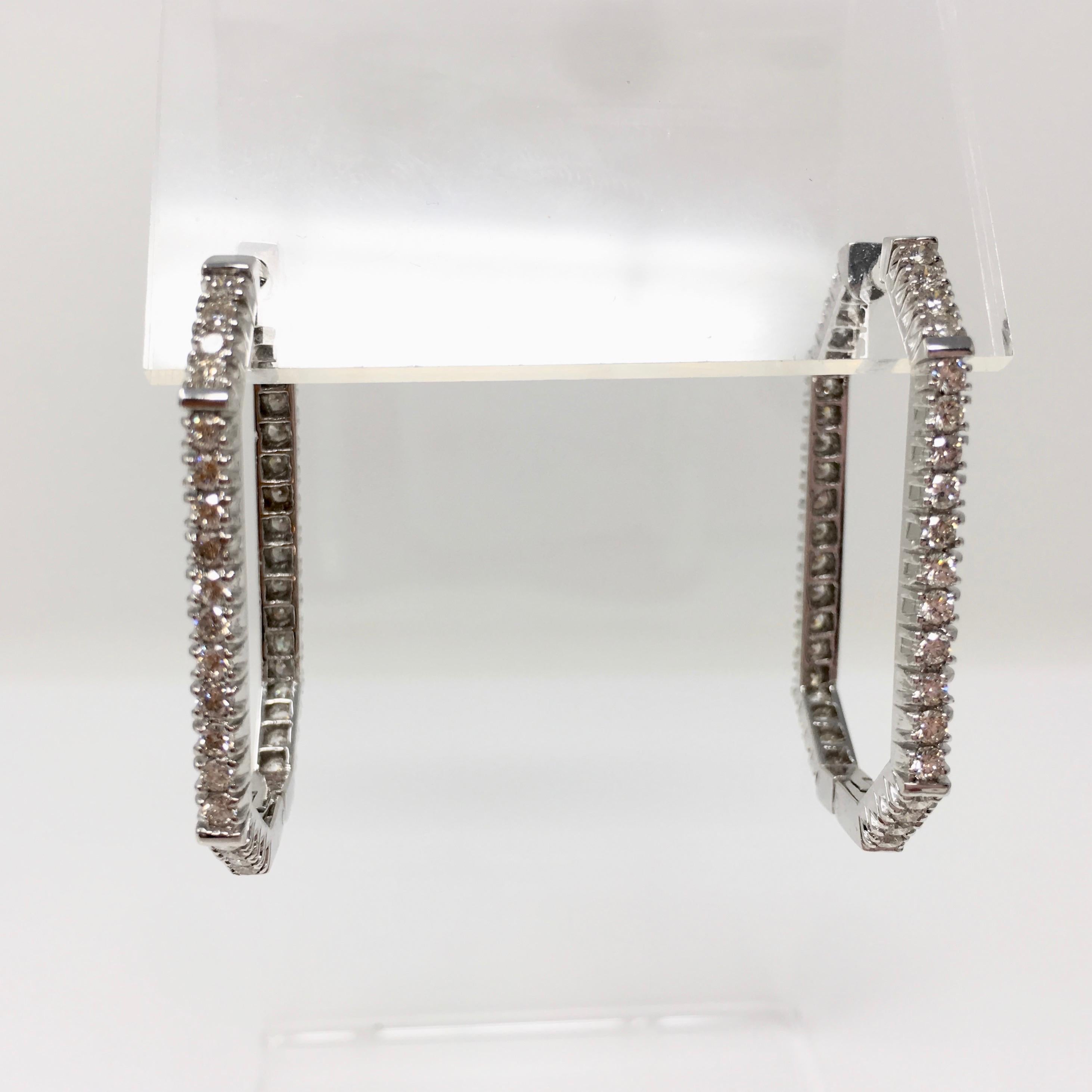 These highly fashionable earrings are perfect for evening or day wear. These are beautifully handmade by Moguldiam Inc in 18K white gold with diamonds weighing 1.95 carat with VS clarity and GH color creating an incredible sparkle. These hoop