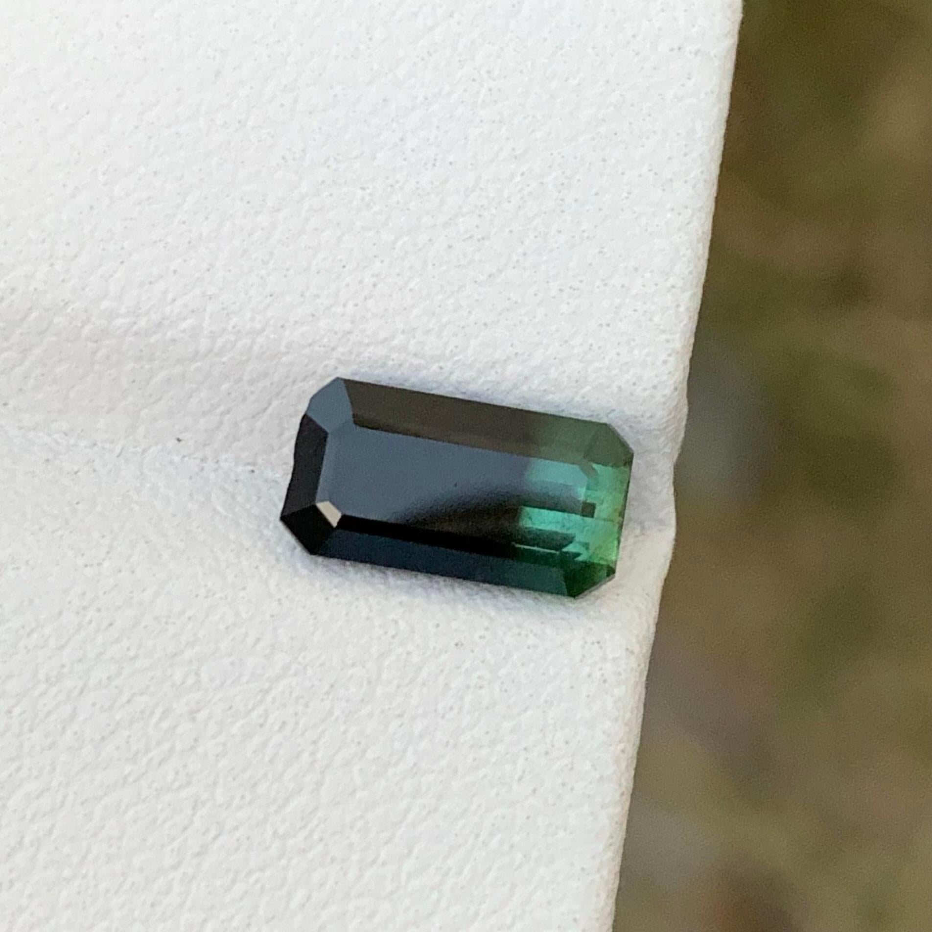 Loose Tourmaline 
Weight: 1.95 Carats 
Dimension: 9.8x5.2x4.3 Mm
Origin; Skardu Pakistan 
Shape: Emerald 
Color: Green & Black
Treatment: Non
Bicolor tourmaline is a stunning gemstone known for its unique and captivating coloration. This remarkable