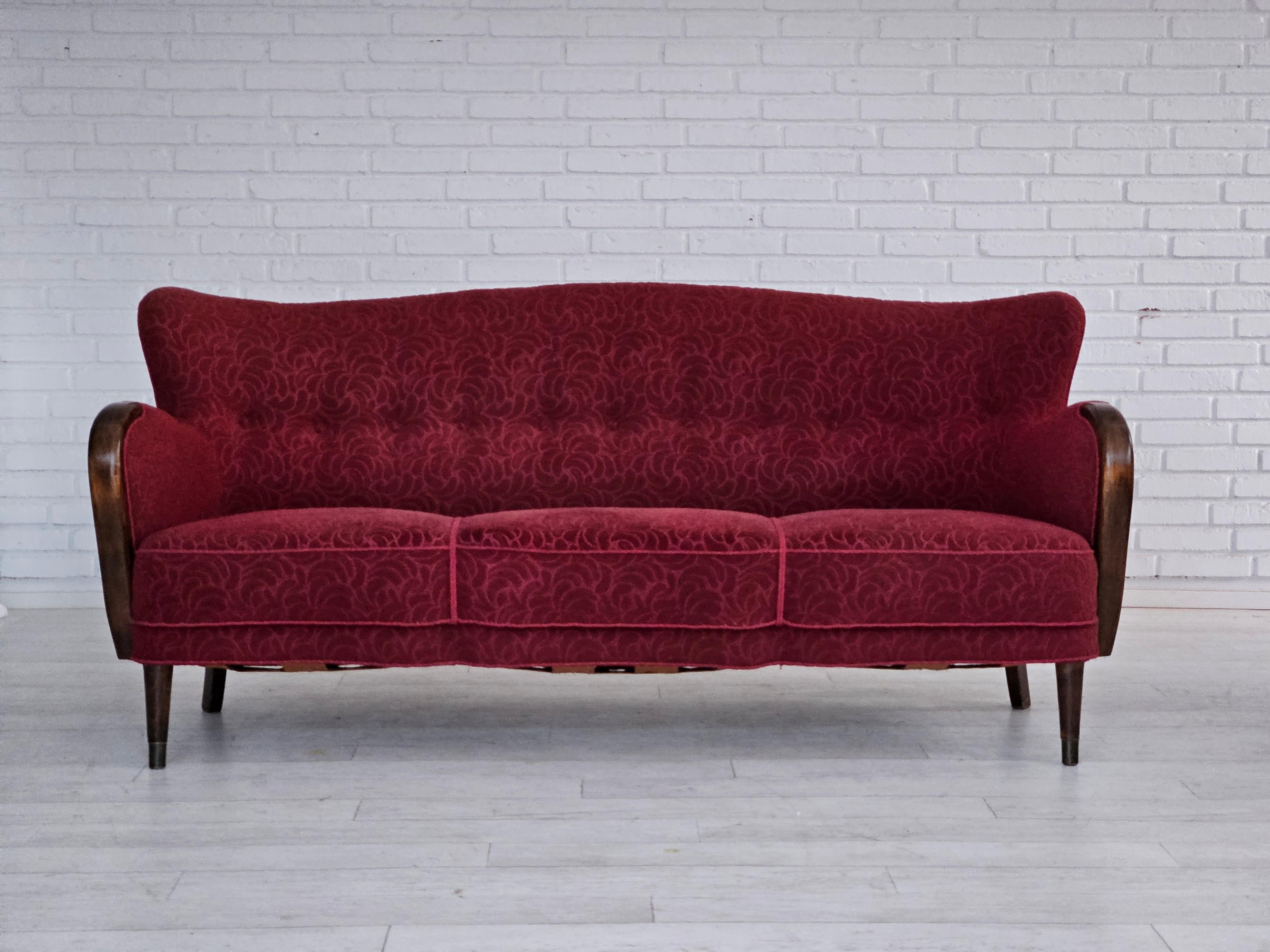 1960s, Danish 3 seater sofa in original very good condition: no smells and no stains. Original red cotton/wool furniture fabric, beech wood legs with brass plugs, brass springs in the seat. Manufactured by Danish furniture manufacturer in about