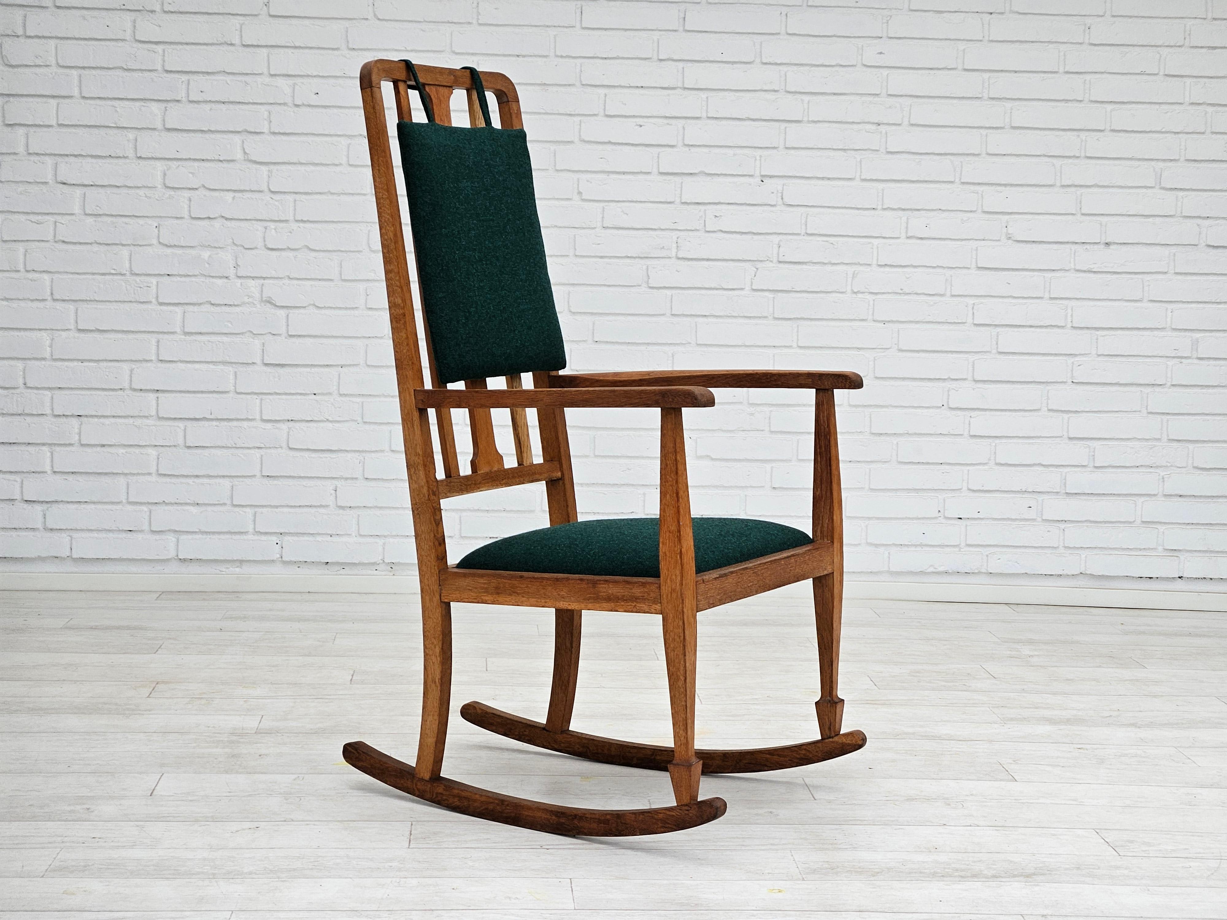 1960s, Danish reupholstered highback rocking chair. Oak wood and KVADRAT green furniture wool fabric Tonica 2. Wood renewed. Manufactured by Danish furniture manufacturer in about 1960s. Reupholstered by craftsman.