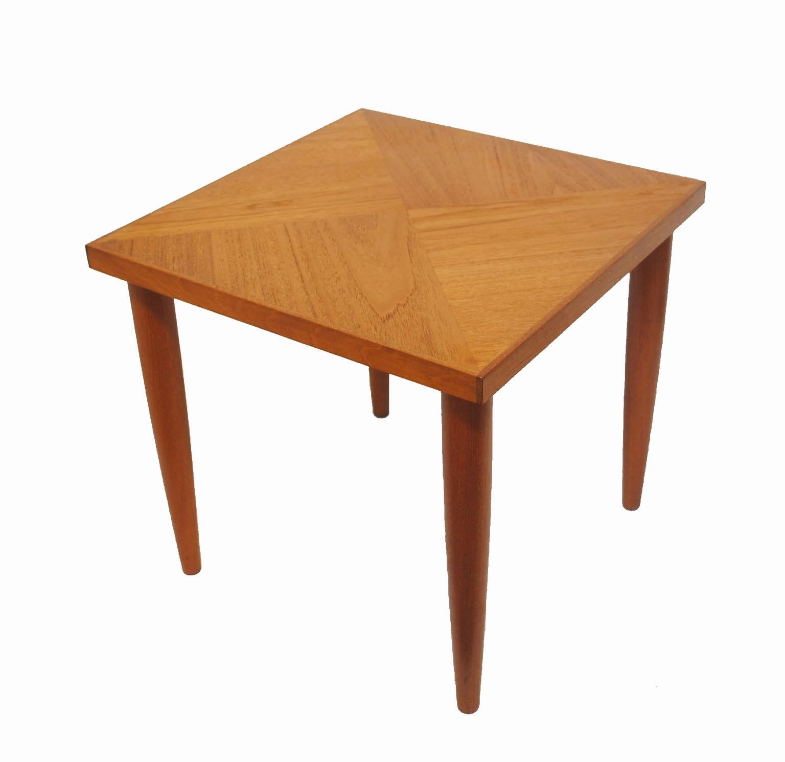A gorgeous pair of teak occasional side tables from the 1950-1960s Mid-Century Modern era. Amazing Scandinavian Modern inspired craftsmanship throughout featuring a stylish cross-grained top and tapered conical legs. Pair is in overall excellent