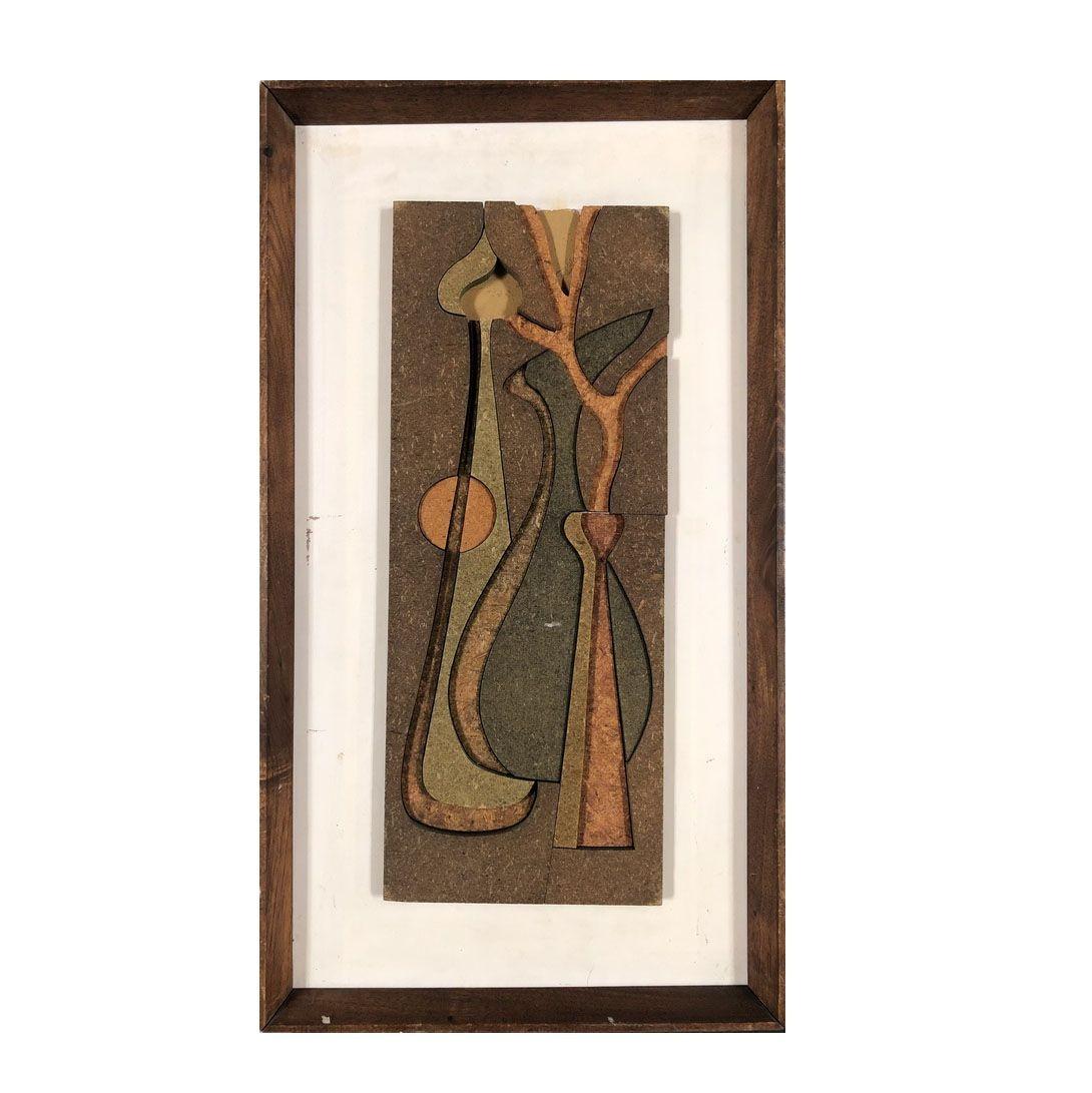 Pair of 3D abstract wall sculptures each featuring a still life depicting a table setting of 3 vases made from layers of sculpted fiberboard in original artist's chosen oak picture frames. Each piece of art features shades of green and brown on a