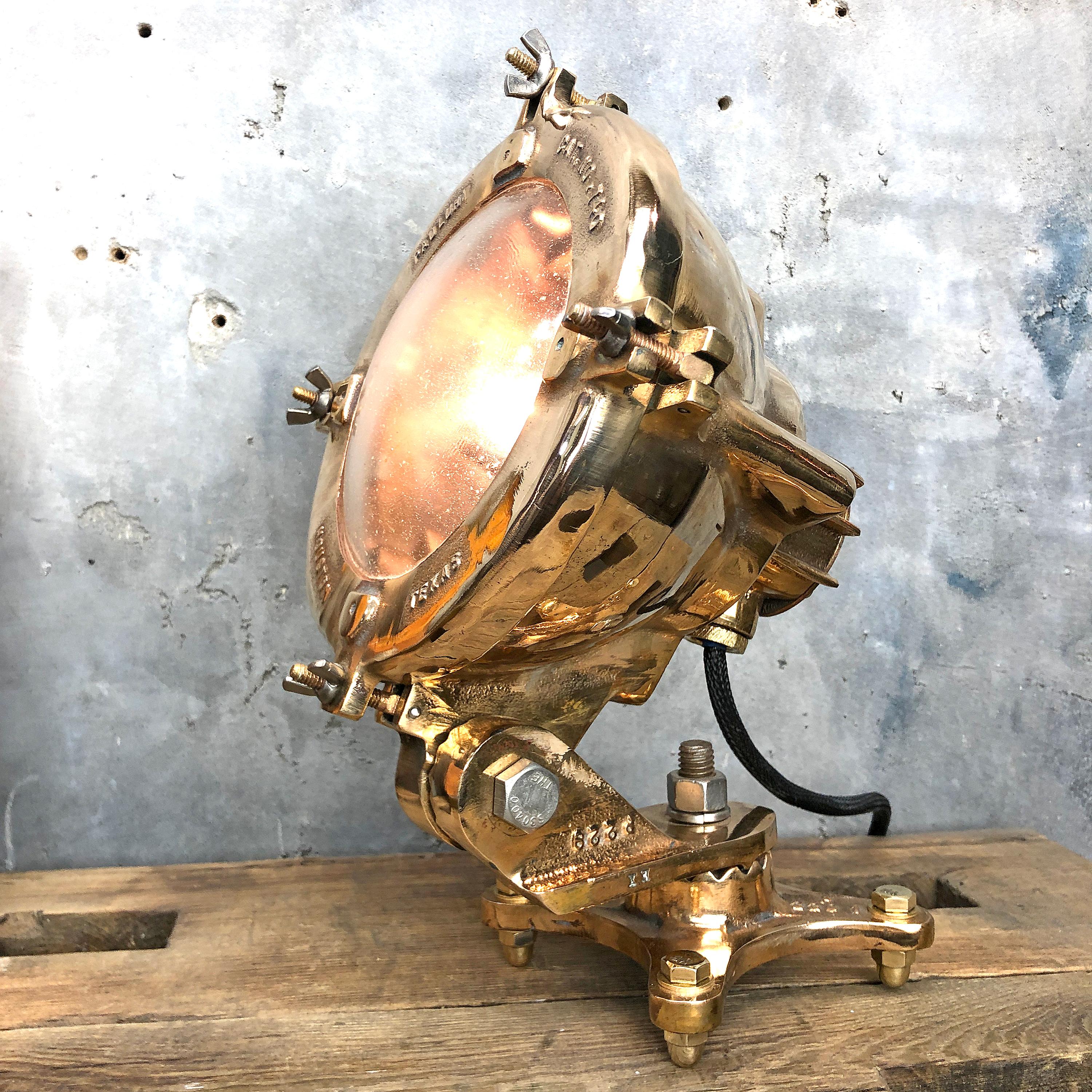 A vintage industrial 1950s American cast bronze table lamp made in Houston Texas by Pauluhn a subsidiary of Crouse Hinds.

It has been manufactured using cast phosphor bronze with a tempered convex glass protective cover. 

The fixture shows