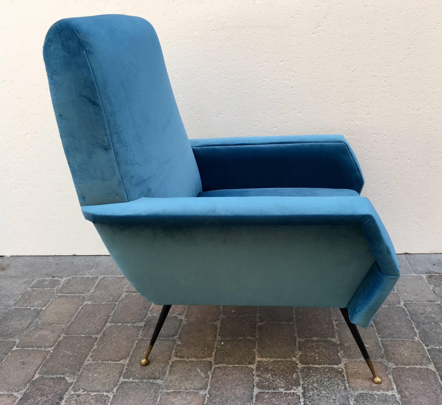 Armchair with solid wood structure and metalic legs lacquered black, finished in brass, upholstered in blue velvet.The upholstery on the armrests and upper part has worn