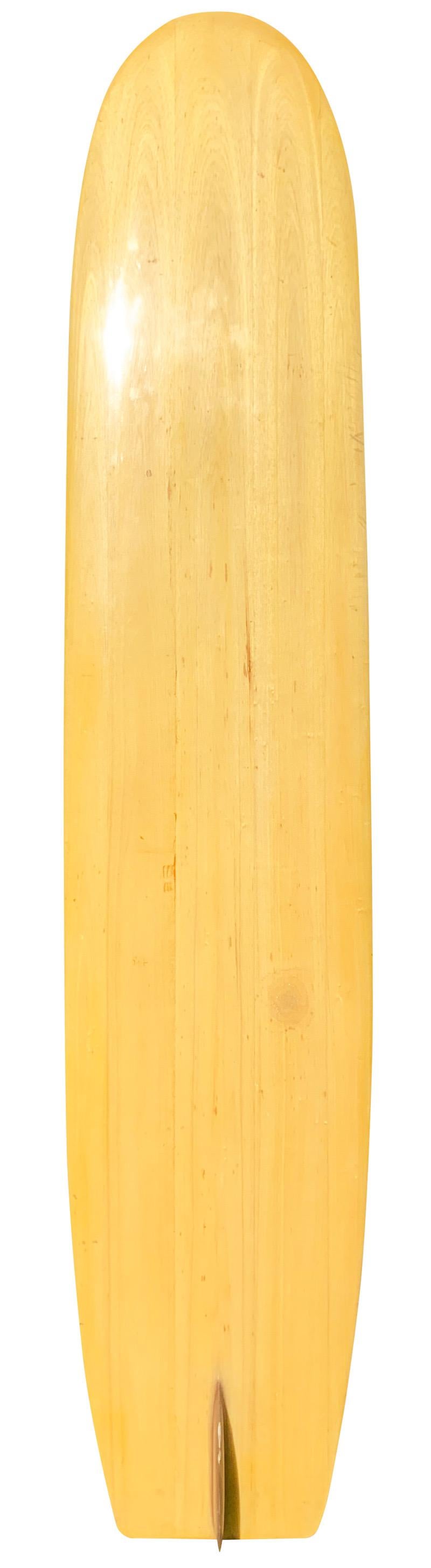 1950 Bob Simmons solid balsa wood longboard replica shaped in the 1990s. Made by former Yater Surfboards shaper Dan Highland. Features an early balsawood surfboard shape-design with early redwood single fin. Made using the 1950 Bob Simmons longboard