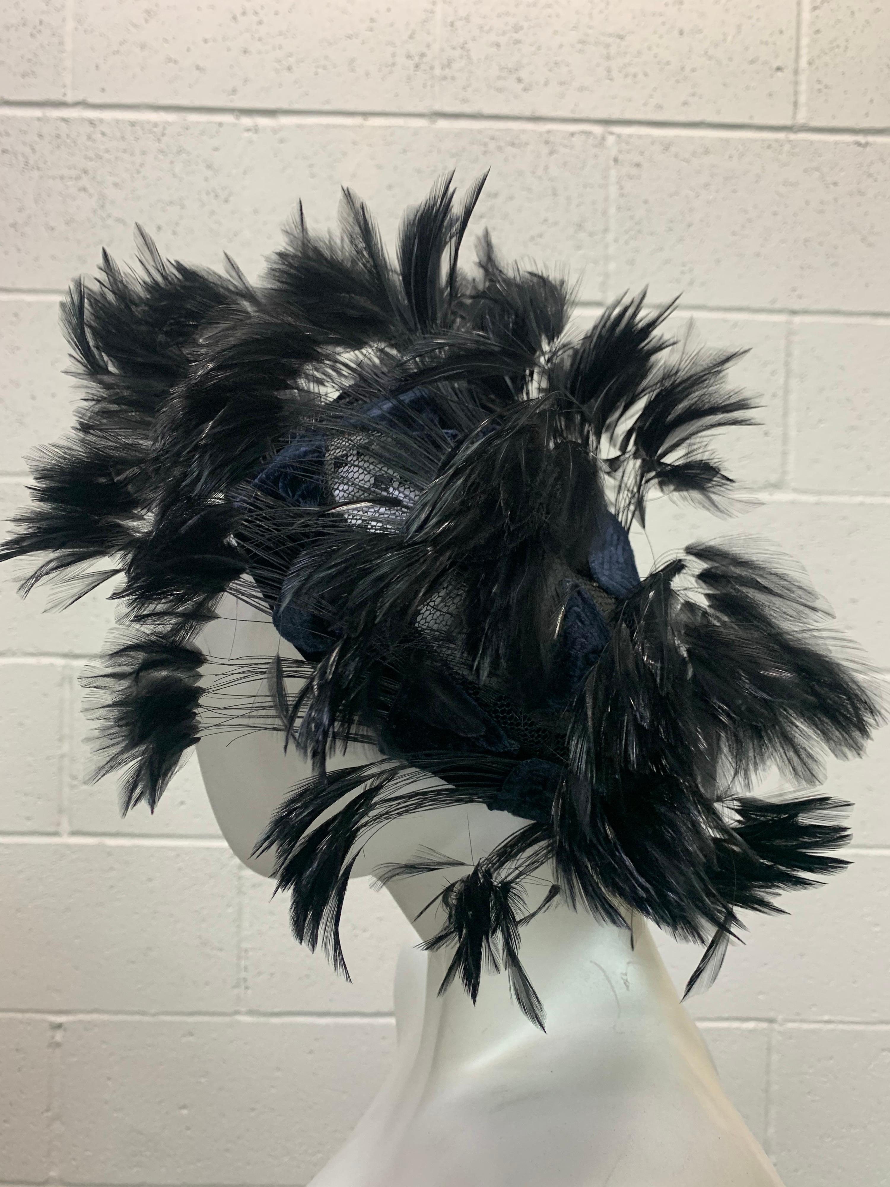 1950s Christian Dior Chapeaux black feather tufted turban with velvet triangle applique details. Satin band and a tulle structured crown are covered in applied feathers and velvet stitched triangles. Quite a striking silhouette with the wisps of