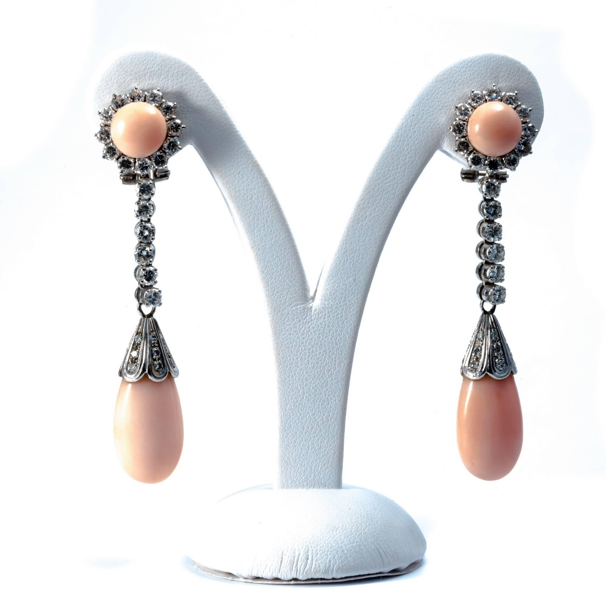 Classic and romantic cluster earrings are dangling with a row of extra white diamonds and a light pink coral drop.
Upon request, earrings can be adjusted for pierced ears.
