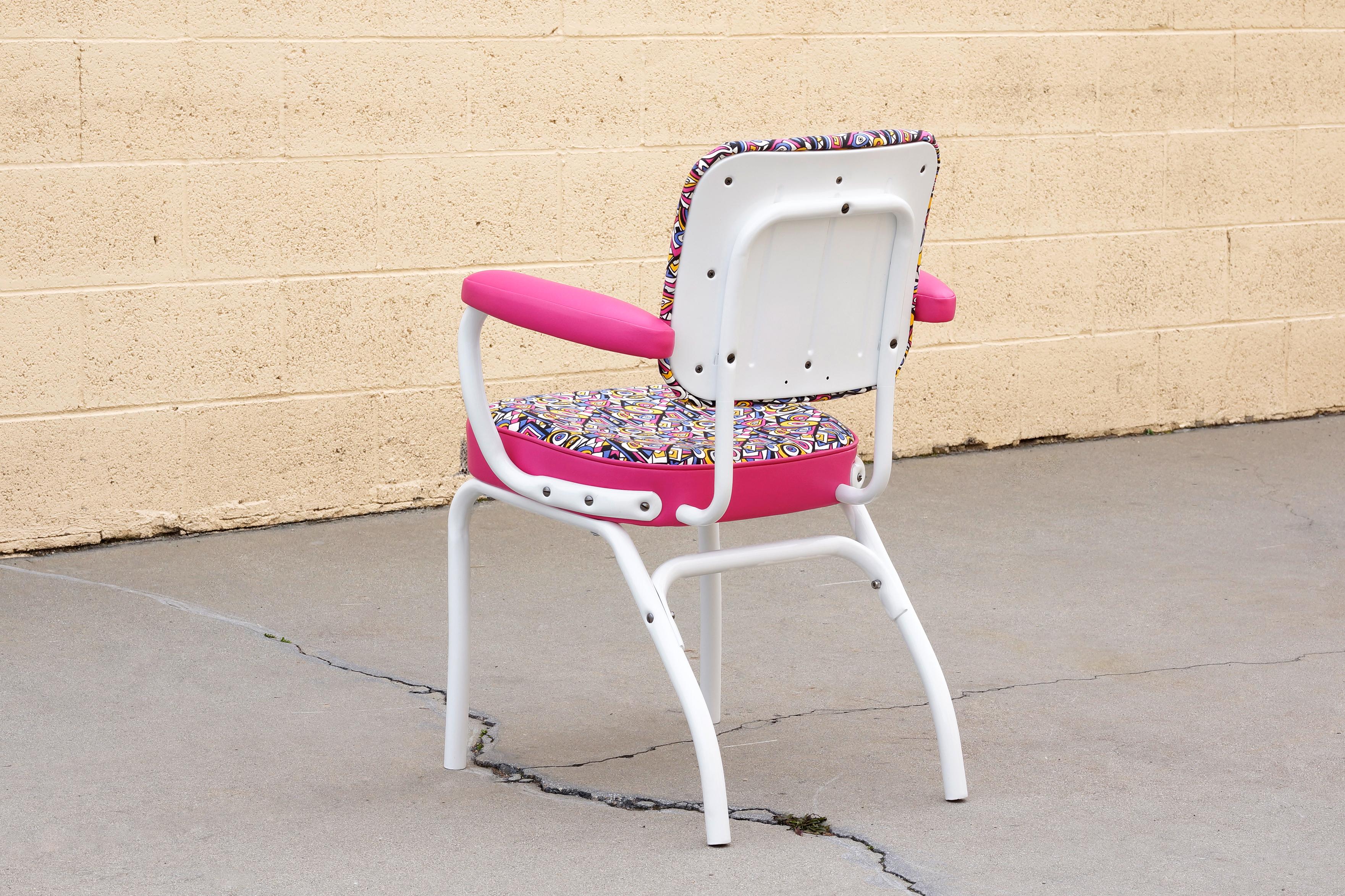 Uber cool 1950s Cosco armchair. We refinished the frame in a gloss white powder coat and upholstered the seat in a retro style fabric with pink vinyl arms. You'll be sitting pretty in pink!

Dimensions: 24