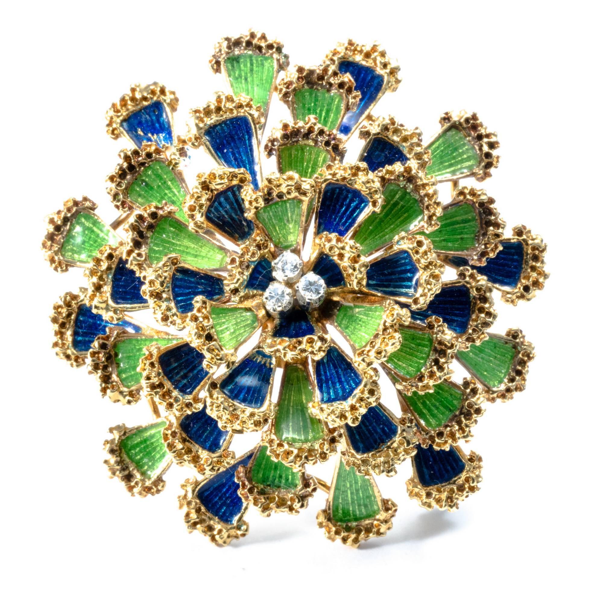 This yellow gold 1950's dome floral brooch is lively and appealing with it's bright blu and green enameled petals, enlightened by 3 diamonds. The pin can be easily wore as a pendant, with an appropriate necklace.