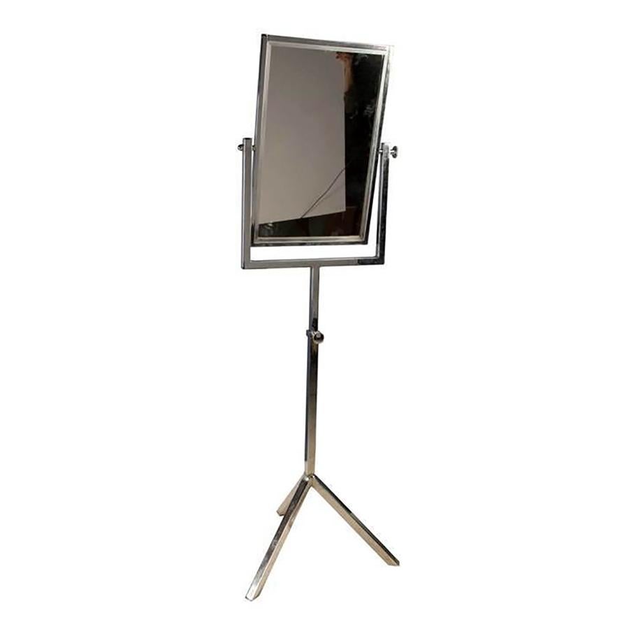 This freestanding chrome dressing mirror is on a tripod stand with adjustable height. Manufactured in 1950, this mirror is a good weight and superb quality, with beveled edging to the mirror plate. This piece allows for the mirror to be positioned