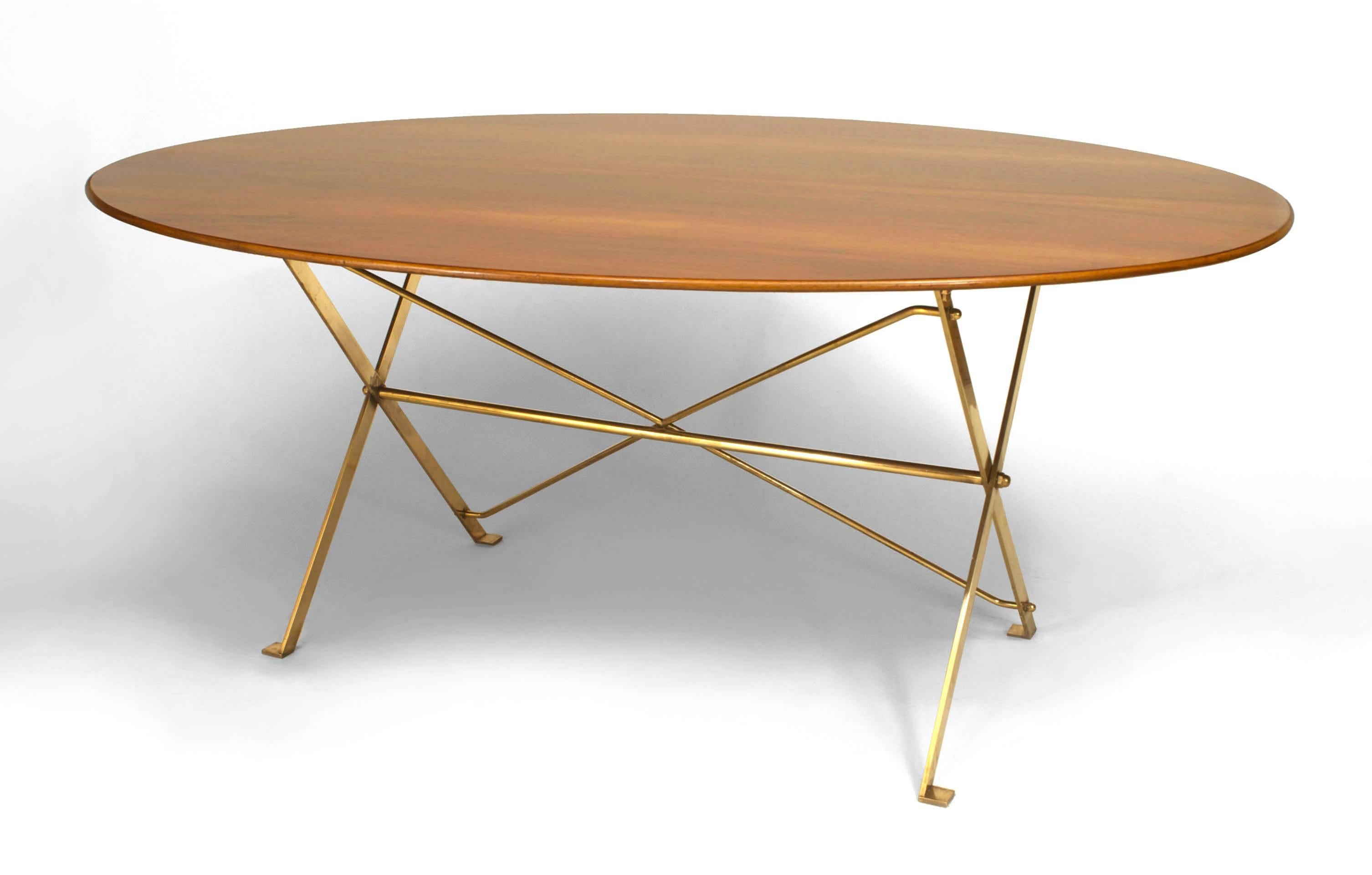 Signed and dated by Italian designer in Azucena in 1950, this dining table features a walnut oval top supported by a brass folding base.